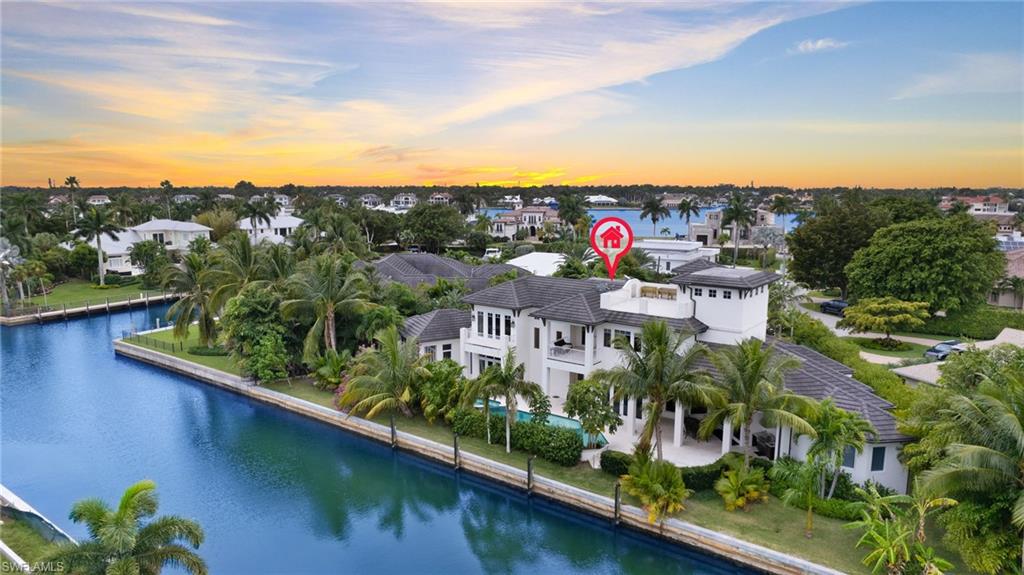 Welcome to 2275 Trout Court in prime Royal Harbor location.  Custom built by local renowned builder, Big Island Builders, this exquisite waterfront home seamlessly blends the indoor outdoor lifestyle. With over 5500 square feet of casually elegant living space this 4 Bedroom, 5 full plus 1 half bath home is sited on almost 200 feet of canal frontage and is truly a boater's dream with direct access to Naples Bay and the Gulf of Mexico.  Open-concept living area featuring a Chef's Eat-in Kitchen replete with Sub-Zero/Wolf appliances.  Living Room with 60" linear gas fireplace. Master suite on the first floor with pool access is a private sanctuary with views of the lush landscaping.  Spa-like En-suite Bath and dual walk-in closets.  Guest suite also with pool entry.  Ascend the dramatic stairwell to the second floor or access it via your 4-stop elevator.  A second Master Suite with private office plus sitting room with front and rear balconies plus additional guest suite.  Third floor rooftop entertaining deck boasts stunning 360 degree bay, canal and sunset views.  Saltwater pool, spa and sun shelf plus outdoor full bath.  Truly exceptional.