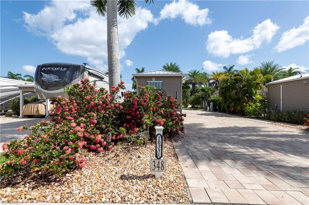 Welcome to Lot 348 in Cypress Trail RV Resort!  This beautifully maintained 35' x 90' RV lot offers the perfect blend of comfort, style, and convenience. Ideally situated across from the lake and just a short 5-minute walk to the clubhouse, pool, and resort amenities, this property is ready for you to enjoy the Southwest Florida lifestyle.

The lot features pavers with an irrigation system and lush tropical landscaping, creating an inviting outdoor retreat. Relax under the spacious tiki hut complete with electrical service, two ceiling fans, and TV hookup—perfect for entertaining or enjoying peaceful Florida evenings.

The finished shed provides additional living space and includes a full bathroom with a large glass-enclosed shower and a premium heated Toto combination toilet/bidet, Roku TV, washer and dryer hookups, air conditioning, hurricane storm panels, and rain gutters for added convenience and peace of mind.

Outdoor entertaining is effortless with the fully equipped outdoor kitchen featuring a Bull propane gas BBQ with rotisserie, built-in storage, refrigerator, and bar seating with five beautiful solid teak stools. Whether you're hosting friends or enjoying a quiet evening outdoors, this exceptional lot is designed for resort-style living.

Don't miss this opportunity to own a move-in-ready RV lot in one of Southwest Florida's premier motorcoach resorts.