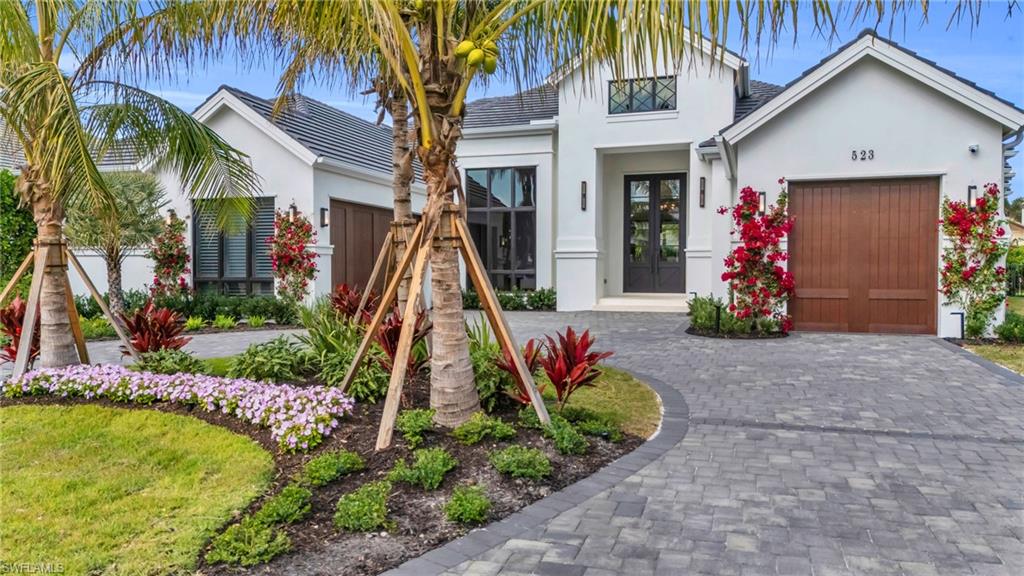 This home features four en-suite bedrooms, a separate office with closet for storage, and two half baths spread out over 4,000 square feet on one floor. The great room floor plan showcases wide sliders to enjoy the view of the pool and spa and has unique touches like a large storage room with built in shelves & hanging, a pass-through pantry for easy access to the kitchen from the garage, and a putting green in the backyard. The ceiling details throughout are stunning with added LED up-lighting. The primary suite includes two large closets.  The home has Creston automation, security cameras and lighting automation you can control from your phone or one of the touchpads inside. A whole house generator is also installed and runs off of a 1,000 gallon propane tank. The covered lanai features a full outdoor kitchen & gas fireplace and is protected by electric screens and hurricane shutters. The backyard has mature landscaping for privacy, a built-in fire pit and synthetic turf for low maintenance.