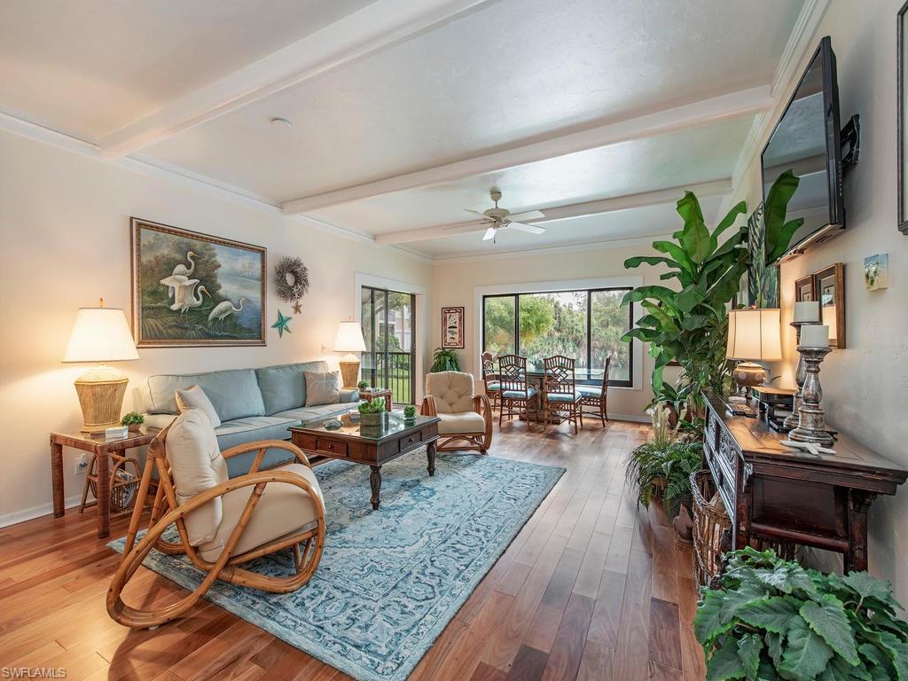 This first floor tropical getaway is TURNKEY and MOVE-IN READY! with designer furnishings and all the comforts of home. Relax and enjoy the beautiful long-lake views. Two split MBR suites with private screened/glassed lanai both offering southern exposure and an abundance of natural light. Each has en-suite bath & walk-in closets. Cherry hardwood flooring throughout the main living and BR areas with easy care saltillo tile in kitchen and baths.The kitchen has updated stainless steel appliances with colorful Mexican tile lending a character all it's own. Unit includes designated, covered carport with extra outdoor storage.  Only a few steps to the community pool with pool house and extensive lounging area. Conveniently located to take advantage of all amenities of Bonita Bay: miles of walking & bike trails, canoe & kayak park, access to Marina Jack's restaurant and private beach on the gulf.