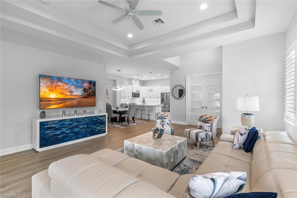 This stunning dahlia floor plan was built in 2021 and is loaded with upgrades! Enjoy the ultimate Naples lifestyle with this fantastic outdoor living space featuring a picture cage enclosing your own private pool and spa that overlooks the lake. Take a look at the open concept kitchen with quartz countertops, including a 3 inch metered edge island. A chef's dream - this kitchen includes an additional wine fridge, expanded cabinetry offering ample storage and much more. There are impact resistant windows and sliders throughout the property. Wonderful details include plantation shutters, electric shades in the living room, upgraded fixtures, custom cabinetry in the primary walk-in closet and more. The Isles of Collier Preserve is a fantastic resort style community with a zero entry resort style pool, a separate lap pool, the Outlook Bar and Grill for dining, miles of walking and biking trails with exercise stations, kayaking, pickleball, tennis, fitness and more. An unbeatable location just minutes from downtown Naples, walking distance to the Bayshore district with plenty of excellent restaurants and bars. What are you waiting for? Start living your dream today!