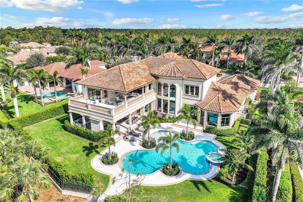 Magnificent estate home built in 2021 on a 0.63 acre lot within the exclusive Escada Estates at Tiburón, Ritz Carlton Golf Resort with an immediate full golf membership available. Bathed in natural sunlight, this home has nearly 7000 SF of interior & 2223 SF of exterior living with 4 bedrooms, 4.5 baths, study, full-size bar, upstairs living area & 4 garage spaces with room for lifts. Home offers a tremendous volume throughout including 29’ tall soaring ceilings in the foyer/parlor. Zero-corner sliding doors fully pocket into the family room walls and lead to your private oasis with a resort style salt-water pool/spa, an expansive lanai & a full-size outdoor kitchen with a pizza oven. Chef’s kitchen features custom cabinetry, 48” Wolf gas range, Sub-Zero refrigerator & built-in coffee maker. A stunning circular staircase leads to upper-level living, 2 guest suites & an expansive lanai with sunset views over the Gold Course’s 15th green. The newest home within Escada with all the modern amenities such as impact windows/doors, custom closets, 4-zones of SONOS in-ceiling speakers, Lutron home control system w/ multi-zone solar shades & 4-zones of HVAC. Tiburon membership is optional.
