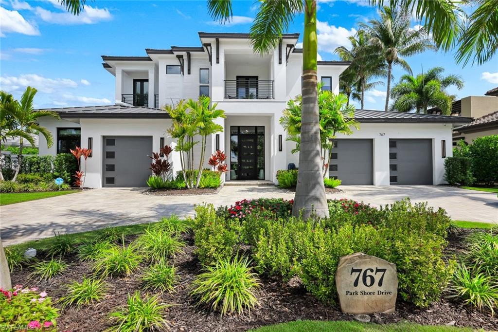 A Modern Coastal Masterpiece in the heart of prestigious Park Shore- offering exclusive access to the private beach park and the opportunity to own or lease a boat slip at the Park Shore Yacht Club.  767 Park Shore Dr is a newly constructed architectural statement just moments from the Gulf’s sugar-white sands, where refined design, modern innovation, and effortless coastal living converge. Spanning nearly 6,500 square feet, this exceptional residence features five en-suite bedrooms, a private study/office, first and second floor laundry, and a bonus/family room-all connected by a private elevator or grand staircase. The home showcases a mastery of craftsmanship, including a climate-controlled wine room, soaring detailed ceilings, bespoke millwork, wide-plank European white oak flooring, and curated designer lighting. The great room, anchored by striking architectural detailing, floor-to-ceiling sliders, and a statement fireplace, flows seamlessly outdoors-blending interior elegance with resort-style living. Outdoors enjoy a private resort setting with a saltwater pool, integrated spa, swim-up bar seating, expansive entertaining areas, lush landscaping, and a fully equipped outdoor kitchen. Motorized integrated screens and Storm Smart hurricane shutters allow for year-round enjoyment. Smart home technology, integrated AV and lighting, advanced security, automated blinds, and a whole-house generator provide modern convenience. The chef’s kitchen features custom cabinetry, dual islands, side-by-side refrigerator/freezers, an 8-burner Miele range, and a Miele steam oven, complemented by a fully equipped butler’s pantry with a built-in Miele coffee and cappuccino station and additional Fisher & Paykel dishwasher drawers. The primary suite is a private sanctuary with a wet bar, soaring beamed ceilings, and dual spa-inspired baths with separate water closets, an expansive multi-function shower, and custom his-and-her closets. Set at 12 feet (per elevation cert) in Zone X the property offers elevation, privacy, and space, complete with a circular drive and split 3-car garage. More than a home, 767 Park Shore Dr is a legacy property minutes to Waterside Shops, 5th Ave S, Third Street S, and Mercato, thoughtfully designed for those who expect nothing less than exceptional.