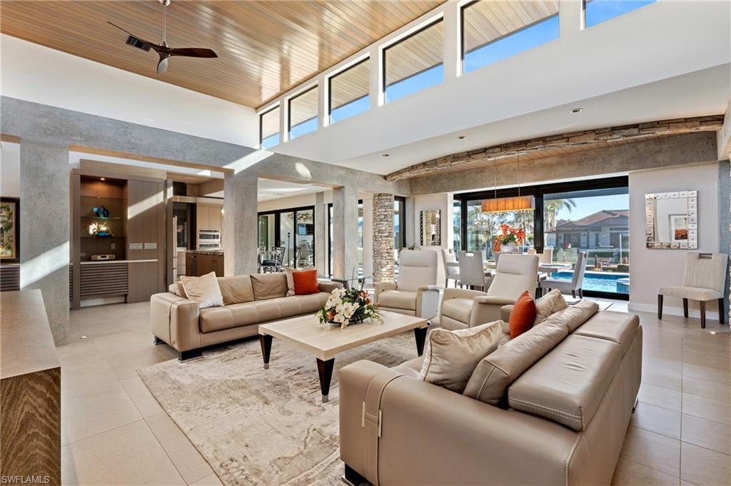 Welcome to your slice of paradise! This stunning custom-designed and meticulously built home is the epitome of luxury, offering high-end finishes throughout. With over 3,100 sq. ft. under air and more than 4,500 sq. ft. under roof, this masterpiece has it all. Being sold fully furnished with an exquisite collection of designer pieces, this 3-bedroom, 3.5-bathroom home also features a sophisticated den, a spacious 3-car garage, and a beautifully crafted dock with a 14,000 lb. lift. Boaters will love the quick access to the Marco River from the desirable north end. The southern rear exposure ensures all-day sun, perfect for enjoying the outdoor living space. Move-in ready, the home boasts an underground propane tank, a gas fireplace, a central vacuum system, fully built-out closets, a screen cage, specialty LED lighting, and countless other upgrades too extensive to list. This dream home, paired with the unmatched lifestyle of Marco Island, offers an unparalleled opportunity to embrace coastal luxury. Don't miss your chance to make it yours!
