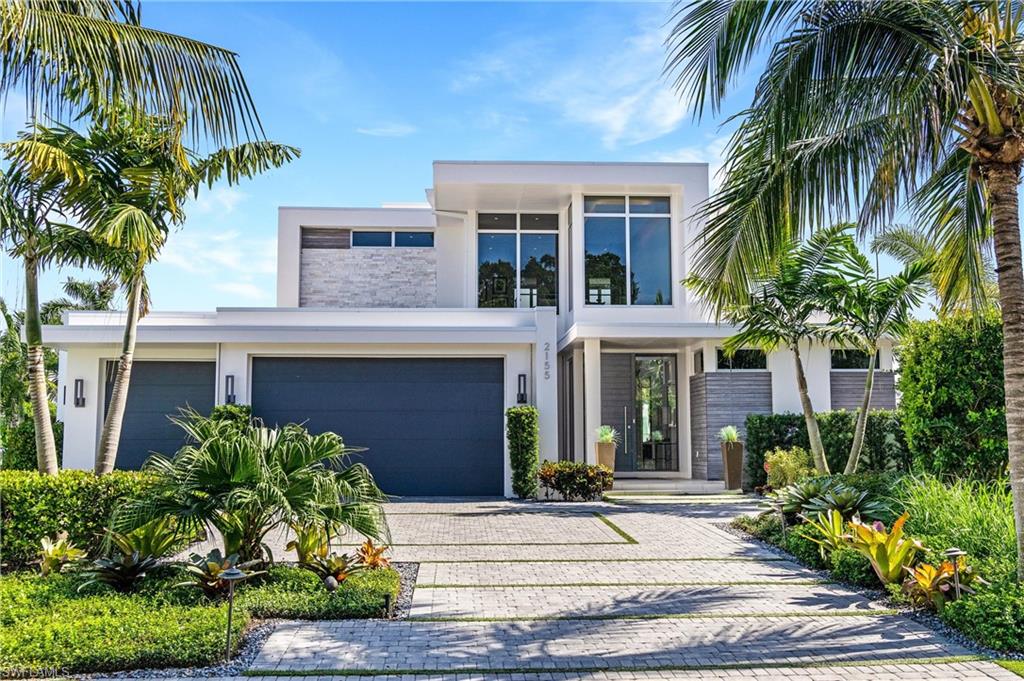 This exquisite, two–story, open concept waterfront home features five bedrooms, five and one–half bathrooms, home office, 170 feet of dock, deep canal, infinity edge pool, three–car garage and is offered turnkey with exceptions. Custom cabinetry throughout kitchen and baths with exceptional tile, lighting, floor to ceiling windows exude elegance. The kitchen was curated to invoke luxury and warmth with custom cabinetry, waterfall island, double oven, cooktop (Wolf appliances) and floor plan intended for upscale but easy entertaining. Owners suite, 1st flr, two walk-closets, soaking tub and magnificent shower. Gracious guest b/r's with en-suite and oversized windows, upper deck with views from every level making this home feel more like a retreat.  The layout of this design provides a feeling of spaciousness and grandeur, along with more intimate spaces like the upstairs loft to retreat to for quiet and solitude. High ceilings and bright outdoor kitchen/grill provide the best in outdoor living with the fire pit providing a toasty feel on winter evenings. Boaters will enjoy maneuvering on this wide water, corner homesite! This is Naples finest in elegant indoor and outdoor living!