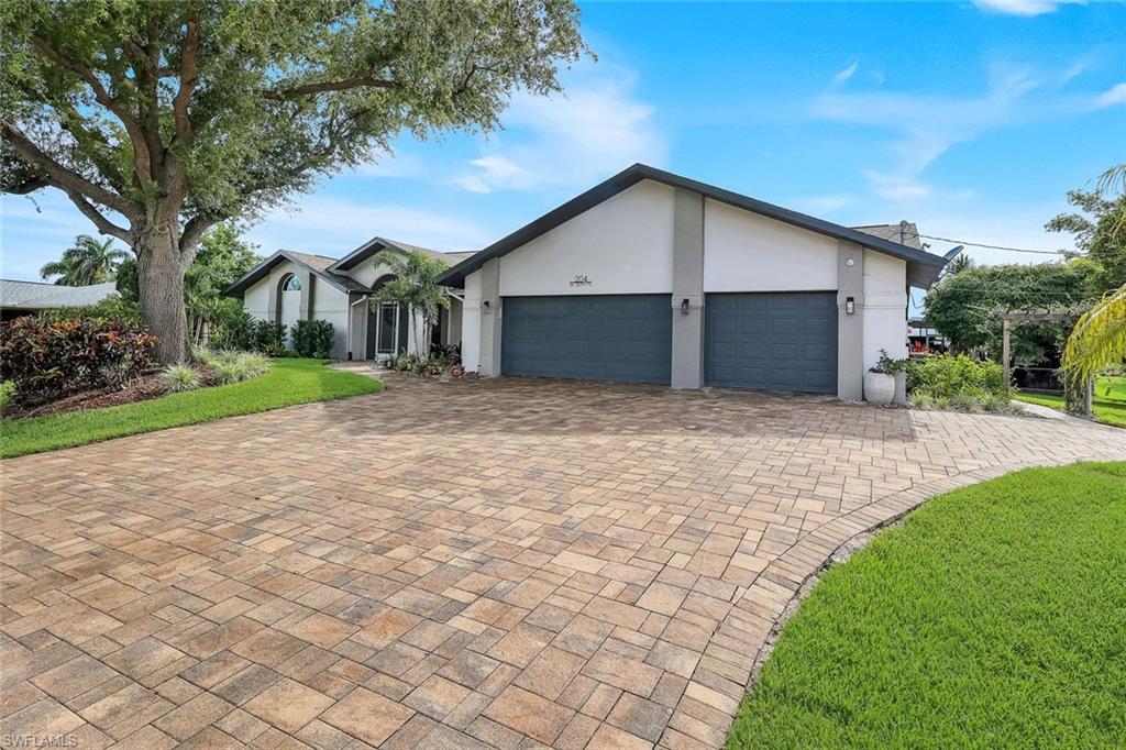 Experience the very best of Southwest Florida living in this beautifully maintained 4-bedroom, 2.5-bath waterfront pool home, offering over 3,100 square feet of living space on an exceptional .40-acre triple corner lot with 145 feet of freshwater canal frontage. Perfectly positioned at the end of a quiet street with virtually no through traffic, this one-of-a-kind property offers outstanding privacy, beautiful mature tropical landscaping, and incredible curb appeal.

Inside, you'll find soaring vaulted ceilings, rich oak flooring, multiple living and dining areas, and a spacious split-bedroom floor plan designed for both comfortable everyday living and effortless entertaining. The well-appointed kitchen features granite countertops, stainless steel appliances, a breakfast bar, pantry, and a new oven, while the inviting living room is enhanced by a stylish electric fireplace.

This home has been meticulously updated and lovingly cared for, featuring impact windows and doors, a newer roof, fresh interior, exterior, and garage paint, a new water heater, and a new irrigation system. The beautifully renovated pool is a true backyard centerpiece, complete with a new pool finish, saltwater system, updated lighting, and WiFi-enabled remote controls, creating the perfect outdoor retreat.

Step outside to the expansive screened lanai overlooking the tranquil freshwater canal, where a concrete dock with water and electric awaits for boating, kayaking, fishing, or simply enjoying the peaceful surroundings. The coveted western rear exposure delivers breathtaking sunset views night after night.

Additional highlights include an oversized 3-car garage, a circular driveway, all city assessments paid, and the added peace of mind of being located in a NO FLOOD ZONE while still enjoying the benefits of waterfront living. Conveniently located close to shopping, dining, parks, and schools, this move-in-ready home offers the perfect combination of luxury, quality, and the Florida lifestyle.