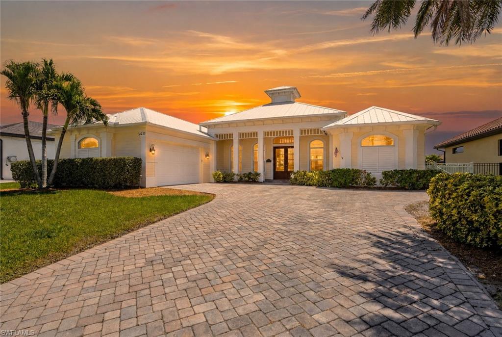 GULF ACCESS. COVERED 10,000-LB BOAT LIFT. HEATED POOL & SPA. FOUR BEDROOMS PLUS DEN.

This coastal contemporary Florida-style home is nestled in one of Cape Coral's sought-after neighborhoods, Four Mile Cove, known for its ecological preserve, scenic walking trails, convenient shopping and dining, and quick access to Fort Myers.

Built in 2014 and offering just under 2,600 square feet of living space, this home features a thoughtfully designed floor plan that maximizes every square foot. A durable metal roof and oversized 2.5-car side-load garage provide lasting value and exceptional curb appeal.

The waterfront is ready to enjoy with a composite captain's walk dock, covered 10,000-pound boat lift with canopy, and quick access to the Caloosahatchee River and the Gulf of Mexico. The outdoor living area is equally impressive, featuring a heated pool with a sun shelf and spa, all surrounded by a spacious screened in paver lanai. Eastern rear exposure provides beautiful sunrise views while helping keep the lanai cooler during the afternoon.

Inside, the open-concept great room showcases coffered ceilings and pocketing sliding glass doors that create a seamless transition between indoor and outdoor living. Adjacent to the primary suite, the den features a closet and built-in fireplace, making it ideal as a fifth bedroom, home office, or playroom.

The kitchen is appointed with granite countertops, stainless steel appliances, a textured tile backsplash, a pantry, and abundant cabinet space.

The primary suite offers direct lanai access and includes a tray ceiling, dual vanities, a soaking clawfoot tub, a spacious dual-entry walk-through shower, and two closets. Just off the kitchen, a private guest suite with a full pool bath provides the perfect accommodations for visitors. Beyond the formal dining room, a separate hallway leads to two additional bedrooms and a full bathroom, creating a true split-bedroom floor plan that offers privacy for family and guests alike.

Additional features include impact-resistant windows and doors, a paver driveway, a fully fenced backyard, city water and sewer with all assessments paid, and the peace of mind that this home has remained high and dry through all of Southwest Florida's recent storms.

Ideally located just north of the Veterans Memorial Parkway bridge, you'll enjoy being only 10 minutes from Downtown Cape Coral and 15 minutes from Downtown Fort Myers, both offering locally owned restaurants, boutique shopping, entertainment, and year-round community events.