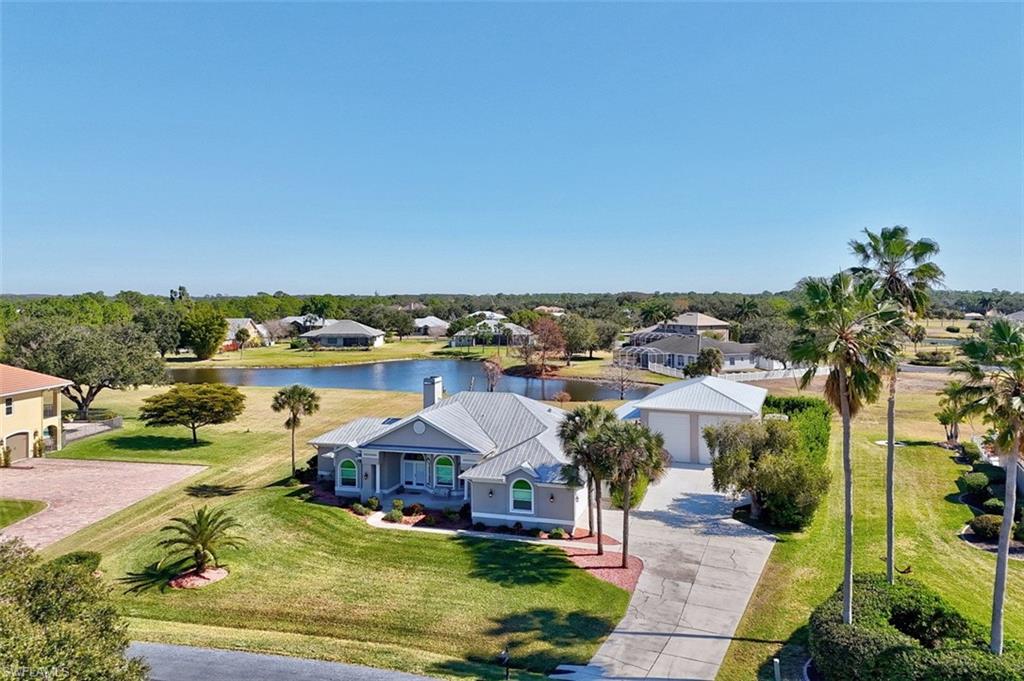 Welcome to the exquisite community of estate homes situated along the Caloosahatchee River in Alva. This waterfront and equestrian neighborhood offers a unique living experience. The property features 3 bedrooms plus a den, 2 full bathrooms, a woodburning fireplace, attached 2-car garage, open floor plan, and high ceilings that allow natural light to flow throughout the home. The house has been upgraded with new kitchen cabinets, granite countertops, new lighting, and new flooring in all bedrooms and the den. Additionally, new insulation (Cellulose R-30 grade blown) has been installed. A detached 23x50 shop garage includes a 12x14 impact and insulated automatic doors, with a car lift recently added, making it perfect for car enthusiasts or those in need of a workspace or extra storage. Adjacent to the garage is a brand-new composite deck, providing ample parking space on concrete at the back or side of the garage. The property sits on .94 acres of beautifully landscaped land, offering breathtaking lake views and a serene environment for entertaining. There is plenty of space for a pool and more.

The home boasts a metal roof, metal trusses, newer air conditioning and duct work, a whole-house osmosis system, all new stainless-steel appliances, an ADT alarm system, newer impact windows and doors, new window treatments, exterior lighting, and keypads for both the detached and attached garages. Riverwind Cove is renowned for its well-maintained homes and spacious estate lots.
Residents can enjoy the peaceful lifestyle of Alva while being just a short drive from Babcock Ranch and I-75, providing easy access to shopping, dining, and all that Southwest Florida has to offer. This community offers the best of both worlds - elegant rural living with modern conveniences. Outdoor enthusiasts can explore the 1,175-acre Alva Scrub Preserve, featuring hiking, equestrian, and bicycle trails managed by the Lee County Conservation 20/20 program. Access to the Caloosahatchee River and nearby public boat ramps make it an ideal location for boating and fishing enthusiasts.
To truly appreciate this exceptional ownership opportunity, please view the Virtual Tour link and extensive photo collection.