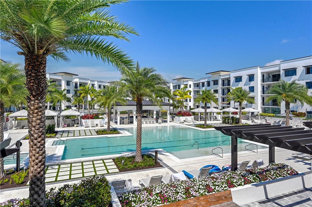Welcome to ELEVEN ELEVEN CENTRAL in Downtown Naples. This sought after Duval floor plan with 3 bedrooms and 3.5 bathrooms, upgraded appliances and wood floors is one of only two elevated terrace units in the complex. With over 800 square feet of additional terrace space perched directly above the amenity deck, you will enjoy views of the luxurious pool with two 90' lap lanes, hot tubs, bocce courts, putting green and lushly landscaped park. Eleven Eleven Central also offers six suites available to residents for over flow guests and a Beach Shuttle to take residents around town. Other amenities include a social room, game room, movie theater and fitness center with massage rooms - all fully equipped and well appointed. Enjoy your morning coffee at Narrative, the on premise coffee shop. Want even more zen and relaxation? ELEVEN ELEVEN CENTRAL is about to welcome a brand new yoga studio. All this and more - just 3/4 of a mile to the beautiful beaches of the Gulf of Mexico and a short walk to Fifth Avenue. This is an absolute must see and rare opportunity.
