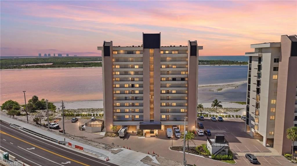 One or more photo(s) has been virtually staged, AI generated or rendered.  Experience refined beachfront living from this beautifully positioned 2-bedroom, 2-bath residence on the coveted south end of Fort Myers Beach. Showcasing captivating Gulf views and picturesque vistas of the New Big Carlos Pass Bridge, this coastal retreat offers an exceptional blend of serenity and sophistication. Expansive windows invite natural light and frame stunning sunsets, creating an ever-changing backdrop of sea and sky. Residents enjoy resort-style amenities, including a sparkling community pool, tennis courts, and direct access to the sugar-white sands of the Gulf. Perfectly situated to enjoy the best of island living, this residence presents an outstanding opportunity to embrace the relaxed elegance and beauty of Fort Myers Beach.