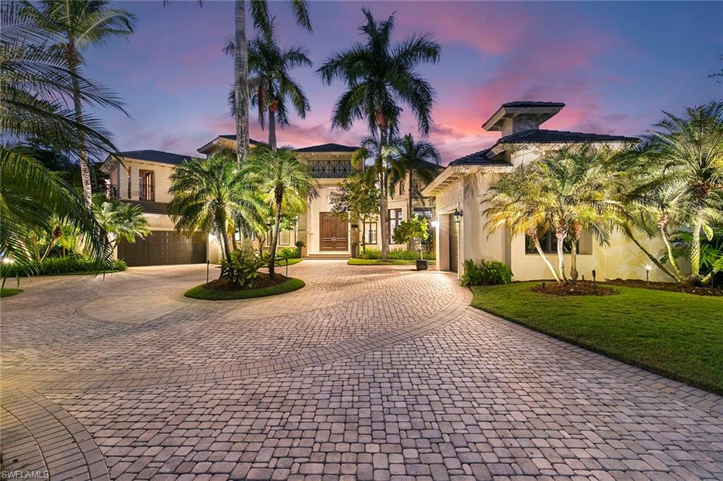 Behind the gates of The Estates at Bay Colony Golf Club, this custom residence by Kraft Construction is a one-of-one offering, designed for buyers who want privacy, presence and a home that lives beautifully in every season. In a lush garden setting with a prized golf-course view, the home pairs soaring ceilings with warm wood floors and bespoke millwork, tile and finishes. At the heart of the home, an expansive renovated kitchen anchors daily life and effortless entertaining with generous prep space, abundant cabinetry and a layout made for family breakfasts, catered evenings and everything in between. The adjacent family room is elevated by a dedicated bar, creating a natural gathering space that transitions seamlessly from casual afternoons to cocktail hour. Throughout, the scale is impressive yet comfortable, with thoughtful sight lines, volume, and architectural detail that signal custom quality. Featuring four full bedroom suites, including a standout cabana guest suite that offers a rare sense of separation and independence. Connected by a covered and screened outdoor living area, the cabana creates the feel of a private guest wing, ideal for long-stay visitors, multi-generational living, or anyone who values their retreat. A home office supports a work-from-home lifestyle. For evenings in the club room (optional fifth bedroom), it is a destination of its own, complete with an additional full bath, making it ideal for game-day hosting, movie nights, or a relaxed lounge that keeps entertaining contained and comfortable. Outdoor living is equally compelling, including a covered and screened sitting area with fireplace and a summer kitchen with built-in grill that sets the stage for alfresco dining, while the large pool and spa invite quiet mornings, sunlit afternoons and lingering evenings under the palms. The overall effect is a private, resort-style backdrop with calm beauty of the golf course beyond. Life here includes membership to the Bay Colony Beach Club, offering beachfront dining, a beachside pool and chair service for effortless days on the Gulf. Residents also enjoy access to the Pelican Marsh fitness and tennis and pickleball center, adding a second layer of lifestyle value beyond the gates. Bay Colony Golf Club membership is optional, giving owners the freedom to enjoy the setting and amenities now, and decide on golf later. Extraordinary in finish, rare in layout and unmatched in lifestyle access, this is one of Naples distinctive golf course offerings, created for those who want a refined home that entertains flawlessly, lives privately and delivers the Bay Colony standard of elegance.