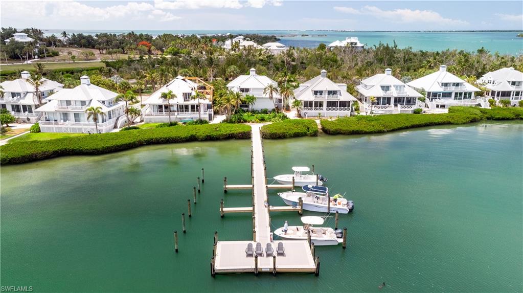 Introducing Laguna Cottage, a beautifully updated waterfront villa located within the charming Village enclave of Useppa Island. Positioned to capture picturesque northwest-facing views over Pine Island Sound and the Intracoastal Waterway, this thoughtfully designed 3-bedroom, 2-bath residence with office/den offers 1,708± square feet of air-conditioned living space, an uncommon find among similar units on Useppa. 

This attached villa has been tastefully updated and appointed with impact-rated windows & doors, Serena & Lilly furnishings, and vintage coastal accoutrements, blending timeless coastal character with modern comfort. The open-concept living and dining areas are filled with natural light and showcase captivating water views from both the first and second floors. A welcoming fireplace adds warmth and charm to the main living space, while multiple outdoor seating areas invite quiet mornings, sunset gatherings, and evening stargazing.

The updated and fully equipped kitchen features stainless steel appliances, including a propane range, custom tile accents, abundant cabinetry, and functional workspace ideal for both casual living and entertaining. Rich design details throughout the home include recessed lighting, stylish fixtures, and numerous ceiling fans that complement the island aesthetic. Recent improvements enhance both comfort and peace of mind, including a new roof installed in 2024, two-zoned HVAC systems replaced in November 2024, new tankless water heater, dishwasher, disposal, and propane tank in late 2025. Additional landscape improvements were completed in spring 2026, further enhancing the property’s inviting outdoor setting with lush tropical foliage. Plans to install pavers leading to the entrance are underway, with installation scheduled for the near future.

The flexible floor plan offers the opportunity for a primary suite upstairs or downstairs. On the ground floor is a spacious bedroom with a full en-suite bath, complete with direct access to the wraparound deck. Upstairs is another primary option with a sitting room, separate office, and private balcony overlooking the water toward Boca Grande. Another guest room with Jack-and-Jill bath complements it all. Ownership includes dockage for one vessel up to 24 feet at a community dock located directly behind the cottage, offering convenient access to the surrounding waters of Southwest Florida.

Laguna Cottage offers a turnkey opportunity to establish a true island lifestyle upon closing, complete with the convenience of dockage and world-class water views. Useppa Island is a private membership-only island, and all interested parties are encouraged to explore all aspects of its private Club and what it has to offer residents. The Club came under new ownership in 2025 and is undergoing a comprehensive, multi-million-dollar renovation of its facilities and infrastructure in an effort to create a one-of-a-kind private island experience.