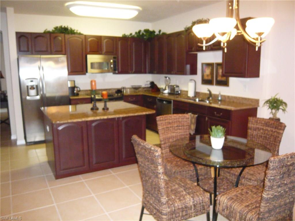 Immaculate 3 bedroom 2 bath condominium is an end unit on the first floor with a beautiful lake view and privacy, certainly A MUST SEE. The original owner has used this home for a vacation and seasonal rental.  The spacious Key Largo floor plan lives like a home and offers ceramic tile throughout the living area, a beautifully upgraded eat-in kitchen with wood cabinets and granite counter tops, Stainless GE appliances, large island breakfast bar that offers an extra work area, large pantry and separate formal dining room. A new A/C system was installed in 2015.  There is no lack for storage as this unit comes with a very large storage closet. There is one designated covered parking space with ample guest parking. Windows are impact glass for Hurricane protection. Marbella at Spanish Wells is a gated community with two community pools to enjoy.  Spanish Wells Golf and Country Club is adjacent and can be accessed directly from within Marbella, it offers many types of social and golf memberships.  Membership is not mandatory. Marbella is located a short 3 miles from the Beach and convenient to Casual and Fine Dining and Shopping.