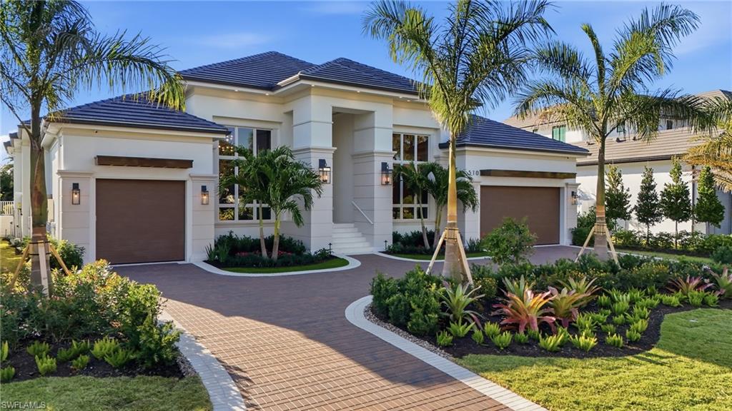 This exceptional new construction residence is built by Borelli Construction of Naples, a premier luxury builder with over 40 years of experience, and is ideally situated on a quiet street in the heart of Park Shore with coveted western exposure, delivering breathtaking sunset skies each evening. Interiors and furnishings are curated by Clive Daniel Home, bringing a refined, sophisticated aesthetic throughout. Thoughtfully designed, the home offers four spacious bedrooms with en-suite baths, two additional half baths, and a versatile office that can easily function as a fifth bedroom, complete with a full bath and generous closet. A striking iron-and-glass front door welcomes you into a grand foyer that opens to an elegant great room featuring a custom architectural wall with integrated LED lighting, wood and stone-inspired accents, and a Samsung Frame TV. Painted ceiling beams seamlessly connect the great room to the chef’s kitchen and butler’s pantry, outfitted with Sub-Zero and Wolf appliances and custom solid wood cabinetry. The dining room includes a wet bar and is framed by floor-to-ceiling windows overlooking the pool. European white oak flooring flows throughout the home, while the split-bedroom layout ensures privacy. The primary suite is a serene retreat with two fully built-out closets and a spa-like bath. A temperature-controlled wine room accommodates over 440 bottles, perfect for the avid collector. Outdoor living is elevated with a covered lanai featuring a gas fireplace, outdoor kitchen, electric screens, and hurricane shutters, overlooking a saltwater pool with sun shelf and spa, plus a convenient pool bath accessed directly from the deck. Additional highlights include hardwired shades, Control4 home automation, Lutron lighting, whole-house generator, beautifully detailed trim work, and designer lighting and plumbing fixtures. Prime location near the upcoming new Publix, Waterside Shops, Venetian Village, and a wide selection of dining destinations, with close proximity to Park Shore Association beach and Seagate Beach.