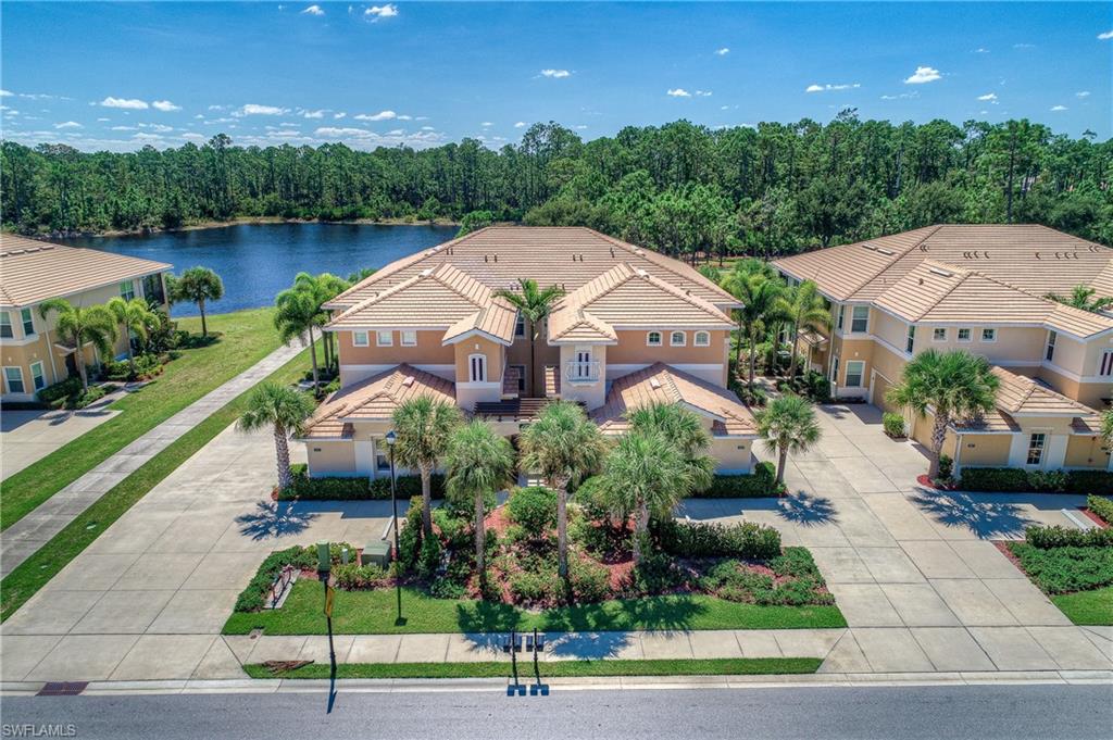 Enjoy this immaculate first floor, attached two car garage, carriage home built by WCI boasting numerous upgrades throughout.  Corner unit with sought after southern exposure, two-sets of sliders lead to the tiled screened in lanai and large corner windows off the breakfast nook, enables natural light to shine through.  Desirable open concept floor plan, tile on diagonal, crown molding, tray ceilings.  Beautiful kitchen offers generous upgrades.  Granite counter-tops, tier cabinetry with crown molding, back-splash tile, under-mount sink, stainless appliances with double oven range and two drawer French door refrigerator.  List continues for upgrades - plantation shutters, California closets throughout, impact windows, reverse osmosis system, water heater and softener.  Spacious master suite offers private sliding entry to tile lanai and ensuite bath provides dual sinks and large walk-in shower finished in tile and accent in-lay.  Home provides neutral tones throughout to fit all decorating palates.