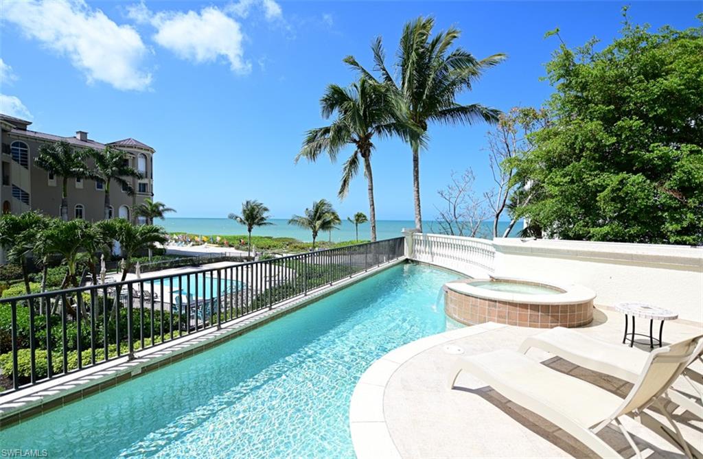 Rare opportunity to purchase a 4 story DCS built Barefoot Beach home with elevated swimming pool on the Gulf of Mexico with south & west exposure. Features include: concrete construction, Anderson Impact windows, large covered lanai, summer kitchen, gas grill, outdoor fireplace & electric lanai shutters & screens, elevated heated pool & spa large enough for laps plus sun deck, upen floor plan with gulf views from the kitchen, dining and 2 story great room with wall of glass & fireplace, wet bar, second dining area & powder bath. Oversized Master suite & bath with wide gulf views and private deck overlooking the pool & white sand beach, plus 3 guest bedrooms with baths, two full sized office rooms & a large recreation room that with one touch converts to a large screen theater room. Walk right out to the beach garden pool and gulf via private walk. Quality finishes and workmanship throughout the home, 3 plus car garage large, unfinished ground floor, private elevator, one touch lighting and AV system. Barefoot Beach is a gated conmmunity with 24 hour guard patrols & inc clubhouse w/fitness, tennis, pickle ball and boat docks across the street that may be available for sep purchase.