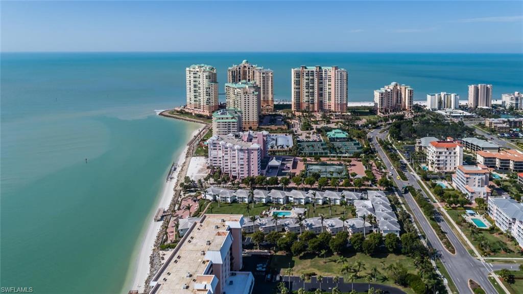 Spacious upscale remodel in gated oceanfront community.  Updated kitchen features custom cabinets, granite countertops, stainless steel appliances.  Very well maintained, split bedrooms, master suite with private bath including custom cabinets, builtins, dual sinks and plenty of storage.  Large screened lanai, perfect for entertaining.  Enjoy the convenience of in unit washer & dryer, plus storage area.  Walk to the beach and enjoy fabulous sunsets, awesome sun deck and fishing pier.  Great location, great community at a great price.  Make this your own piece of paradise and make an offer.