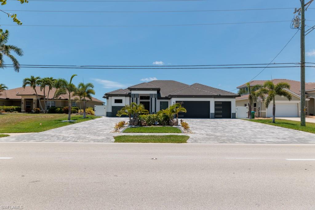 This stunning custom oasis in Southwest Florida is built for luxury and entertaining. 3 bedrooms, 3 bathrooms, plus a spacious den, 3-car garage, tile throughout, an indoor kitchen with a walk-in pantry, and a vast laundry room with a tub. Spa-like bathroom featuring a walk-in shower built for three, and custom-built walk-in closets. Massive resort-style pool with a hot tub/jacuzzi, an oversized lanai, a fully equipped outdoor kitchen, a built-in BBQ, and a pergola for outdoor entertaining that it perfectly blends comfort and a premium coastal lifestyle. Just 14 minutes from the Yacht Club!. Short-term rentals are permitted, making it an excellent vacation home! This home is a MUST SEE because it has so many details that it's difficult to write them all!