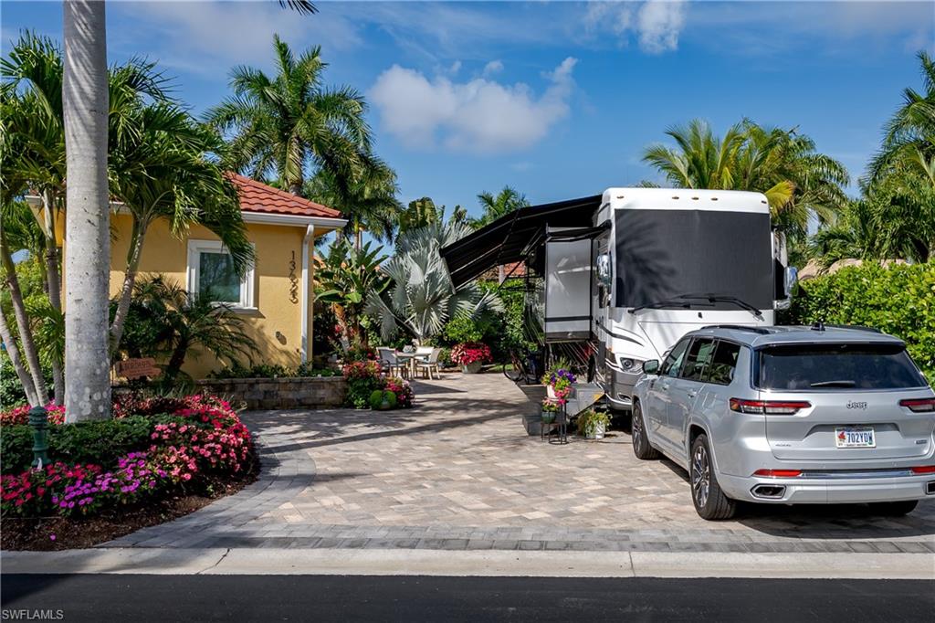 Lot 116 - Welcome to one of the most exceptional properties within the prestigious Naples Motorcoach Resort. A rare lot and a half offering the perfect blend of luxury, space, and tropical elegance. This meticulously curated property delivers a true resort style lifestyle with every detail thoughtfully designed for both relaxation and entertaining.
From the moment you arrive, you’ll notice the expansive pavered site, enhanced by lush, professionally designed landscaping and a unique grassy area, a highly sought-after feature that adds both beauty and versatility to the outdoor space. Vibrant plantings, mature palms, and layered greenery create a private, serene oasis.

At the heart of the property is a stunning oversized tiki hut, ideal for hosting gatherings or enjoying peaceful evenings outdoors. This impressive structure offers ample covered seating and dining areas, perfectly positioned to take in the tropical surroundings while maximizing comfort and shade.

Complementing the outdoor living space is a full outdoor kitchen with sink, wine cooler and finished to the most exacting standards,  a beautifully appointed casita once again finished to the highest standards. Inside, you’ll find the designer kitchen with rich cabinetry, premium stainless-steel appliances, and elegant finishes, along with a spa-inspired bathroom featuring a glass-enclosed shower and upscale fixtures—providing all the comforts of a luxury residence.

This property truly stands apart:
Fully Furnished Indoors and Outdoors, see Inventory List
Rare lot-and-a-half configuration for expanded living and entertaining
Oversized tiki perfect for outdoor lifestyle enjoyment
Full Outdoor Kitchen
High-end casita with full kitchen and bath
Exceptional landscaping with a unique grassy area
Impeccable condition with upscale finishes throughout
Located within Naples Motorcoach Resort, owners enjoy world-class amenities, including a resort-style pool, clubhouse, fitness center, pickleball, and a vibrant, social atmosphere all just minutes from the renowned dining, shopping, and beaches of Naples and Marco Island.
This is a rare opportunity to own one of the most beautifully upgraded, furnished and spacious properties in the resort—where luxury meets the ultimate motorcoach lifestyle. Offered for the most discerning buyer seeking elegance, and exceptional outdoor living.