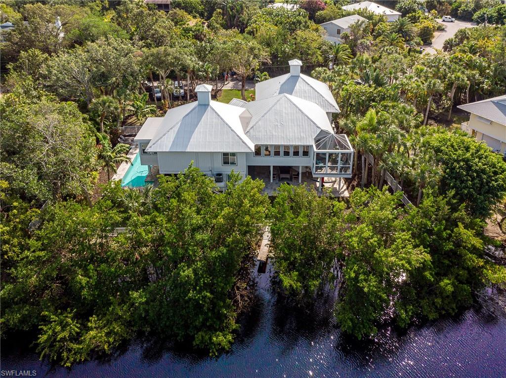 H1051 - Incredible Sanibel Offering!! Shows like a brand new home!! Oversized waterfront lot with all tropical landscape and zoysia grass. This home was entirely remodeled inside and out in 2016-2017. Spacious floor plan features a beautiful Great Room with soaring 18' ceilings, wraparound windows to offer natural light throughout, 4 bedrooms, 3 bathrooms, open concept kitchen with island. Sparkling heated pool and hot tub with overflow make this home the ultimate island residence. Ample storage space and outdoor entertainment areas.