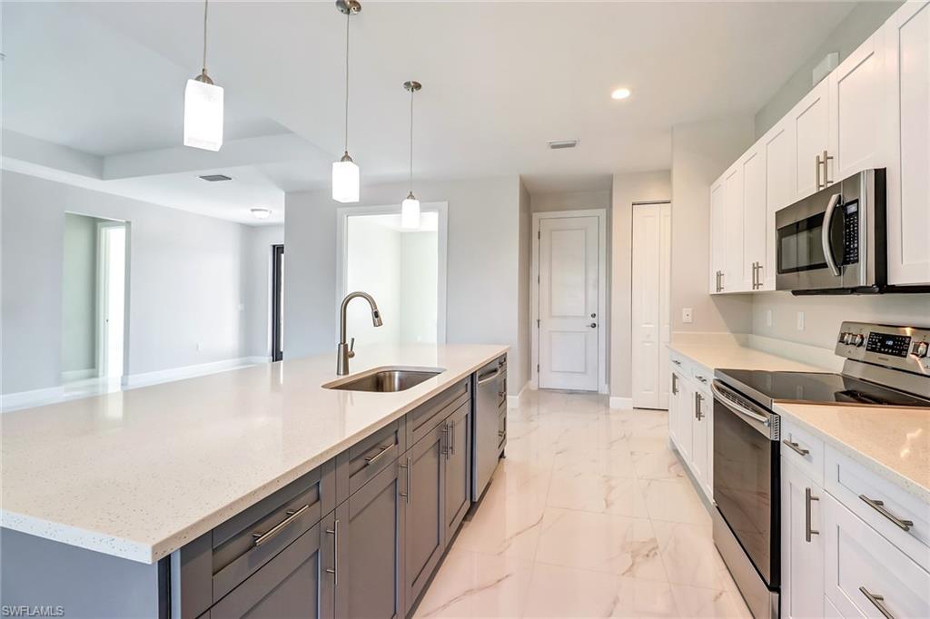 Home is Ready!  Elegant Brand New Construction at a great price in Golden Gate Estates Ready for a family to enjoy. Best of all…No fees No restrictions! As you enter you will feel right at home!  Open floor plan with plenty of light throughout.  Many upgrades such as 8’ doors, Carrera polished porcelain tile throughout, a beautiful kitchen with an island, soft close wood cabinets, quartz counter-tops stainless steel appliances and a pantry.  Huge master with a shower and jetted tub to relax after a hard day at work!  You will be delighted in the Large size laundry room with wood cabinets and quartz counter-top.  This home has 3 bedrooms plus a den, 2 bathrooms, 1,897 sqft under air, sprinkler system and sits on a beautiful 100% upland 2.71 acre lot. Plenty of space to build a pool, guest house in the future, a workshop, bring your RV, trucks,  have animals or just sit and relax at your screened lanai in the morning with a cup of Joe listening to the serenity all around.  Close to the new Publix the new Charter School as well as high school, middle and elementary! Don't delay...at this price this home will go FAST!