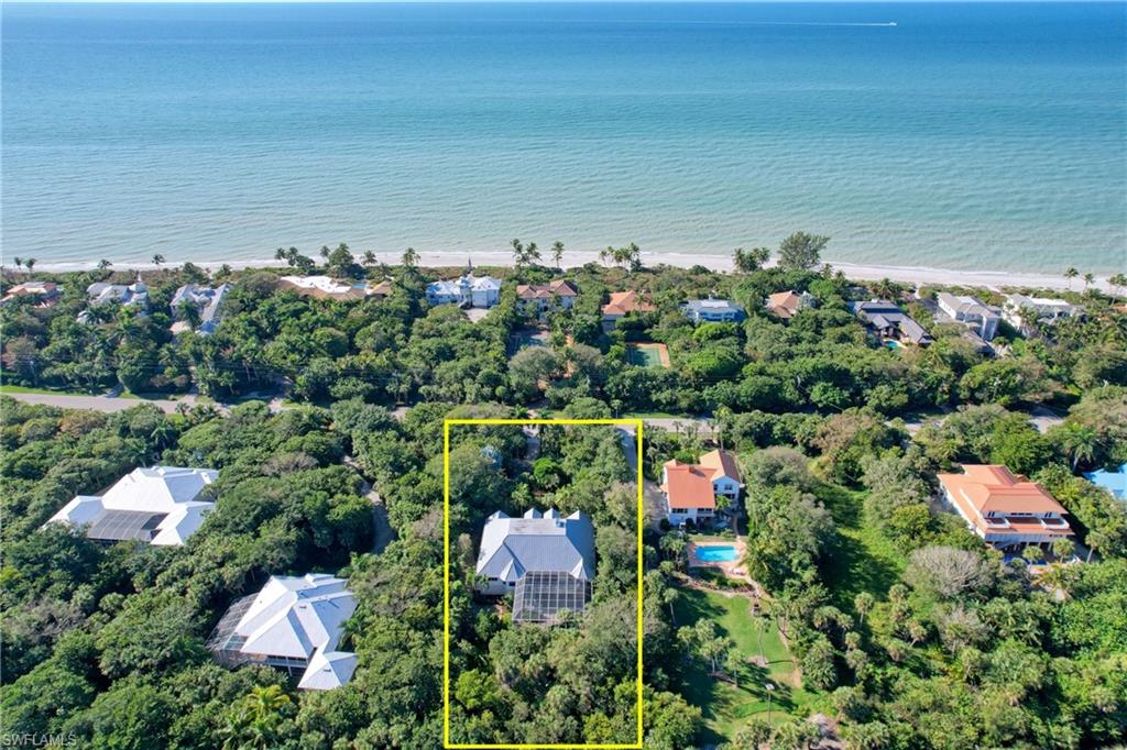 Don't miss the opportunity to own this stunning Wolter Group inspired near beach pool home on West Gulf Dr. with over an acre of land backing up to Sanctuary. This beautiful home features four extremely spacious en-suite bedrooms, gorgeous wood floors, soaring vaulted ceilings, new Quartz countertops, breakfast bar, stainless appliances, additional air conditioned glassed-in lanai flex room, elevator, impact glass, very private heated pool with rock waterfall & aqua link system, new metal roof in 2016, plenty of garage storage for toys, golf cart, cars, etc. This amazing home sits directly across the street from the best beach Sanibel has to offer. The private master suite features a quiet sitting area perfect for enjoying a great book, loads of walk-in closet space with built-ins, rain shower, Toto bidet and plenty of privacy from the guest suites located on the opposite side of the home. This home is perfect for a family compound, entertaining or visiting guests looking for privacy.