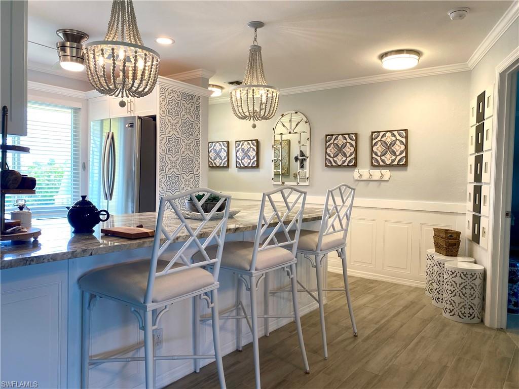 Available for 2027 Season - January or April Only. Welcome to this designer-decorated second-floor, fully renovated unit overlooking the golf course at the 13th tee. This 2-bedroom, 2-bath unit is the perfect place to unwind and relax. Enjoy an open concept living space with a dining area and a breakfast bar for quick meals in the kitchen. The split layout offers privacy from your guests with a King in the owner's suite and a King in the guest room. If you work remotely, use the guest bedroom as an office, as it's fully equipped with a desk area that is private and quiet. Enjoy sunsets on the balcony in this western-facing unit. This unit has all the comforts of home to make the most of your vacation getaway. The Glades Golf & Country Club is the place to enjoy your vacation. This community has 2 golf courses - a par 72 (Pines) and par 55 (Palmetto), tennis, pickleball, shuffleboard, bocce, 10 community pools, a library, and the 19th hole restaurant and Clubhouse. Glades offers art classes, Bingo, Cards & Table Games, Dinner Dances, Karaoke, Seminars, and Tours. Close to downtown Naples for shopping, restaurants, and enjoying the beaches, you can't get a better location. This villa has it all just bring your bags.