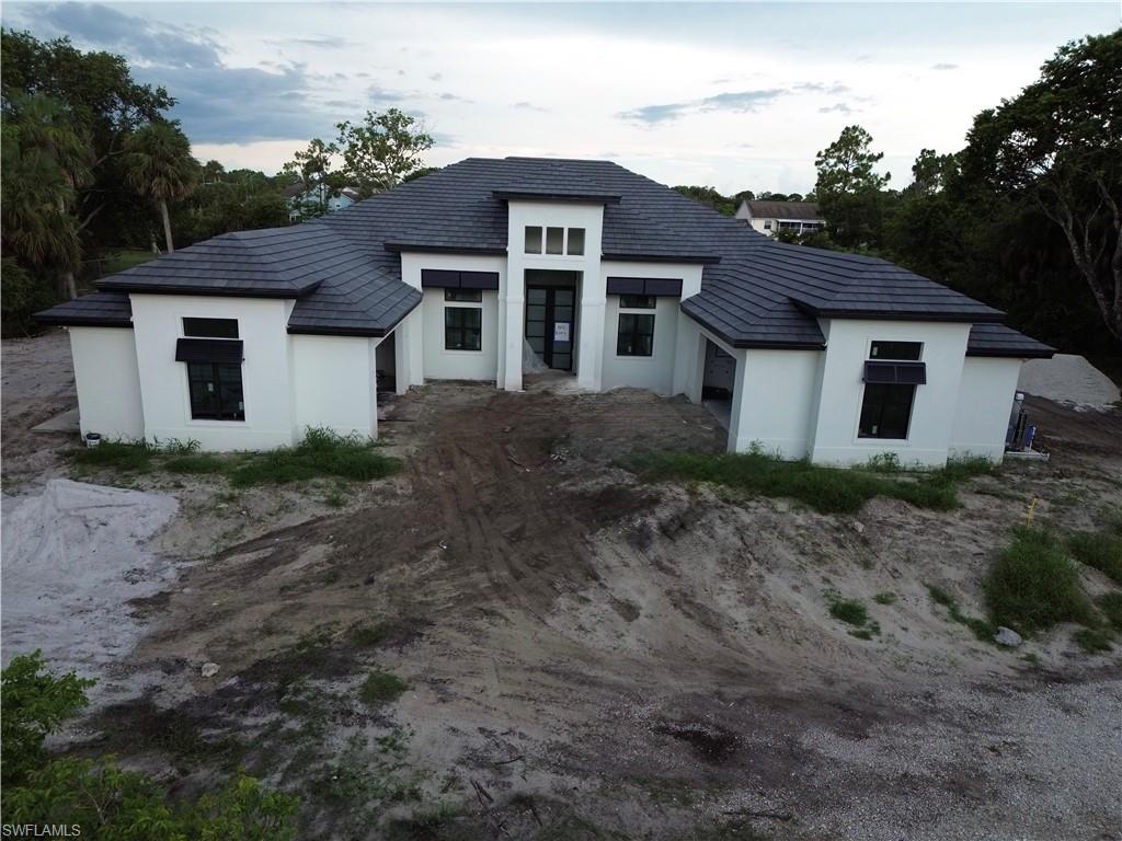 PRE-CONSTRUCTION | CANAL-FRONT ESTATE BY GULFSTREAM HOMES
A rare opportunity to create a luxury canal-front estate in one of Naples’ most desirable in-town acreage settings. This pre-construction residence offers exceptional privacy, generous scale, and refined craftsmanship in a peaceful waterfront environment. Situated along a serene canal ideal for fishing or small boat access.

The thoughtfully designed floor plan includes 4 bedrooms with two primary suites, 4 full baths and 2 half baths, a private office, formal dining room, breakfast nook, exercise or flex room, laundry room, butler’s pantry, and two mud rooms. Expansive indoor-outdoor living is enhanced by a spacious lanai and outdoor kitchen, creating an ideal space for entertaining or relaxing while enjoying tranquil canal views.

This exceptional residence will offer 4,002 square feet under air and 6,357 total square feet, including two spacious two-car garages providing four garage spaces. The expansive lanai is thoughtfully designed for both refined everyday living and elegant entertaining. Enjoy being in your own resort style pool with fire and water bowls to finish the ambiance. The Meticulous attention to detail are planned throughout, creating a truly elevated living experience.

Estimated completion October 2026. Pre-plumbed for a steam shower.  Ideally located just 8 miles from the beach and minutes to premier shopping, dining, and downtown Naples, this property offers the rare combination of private acreage living with in-town convenience.