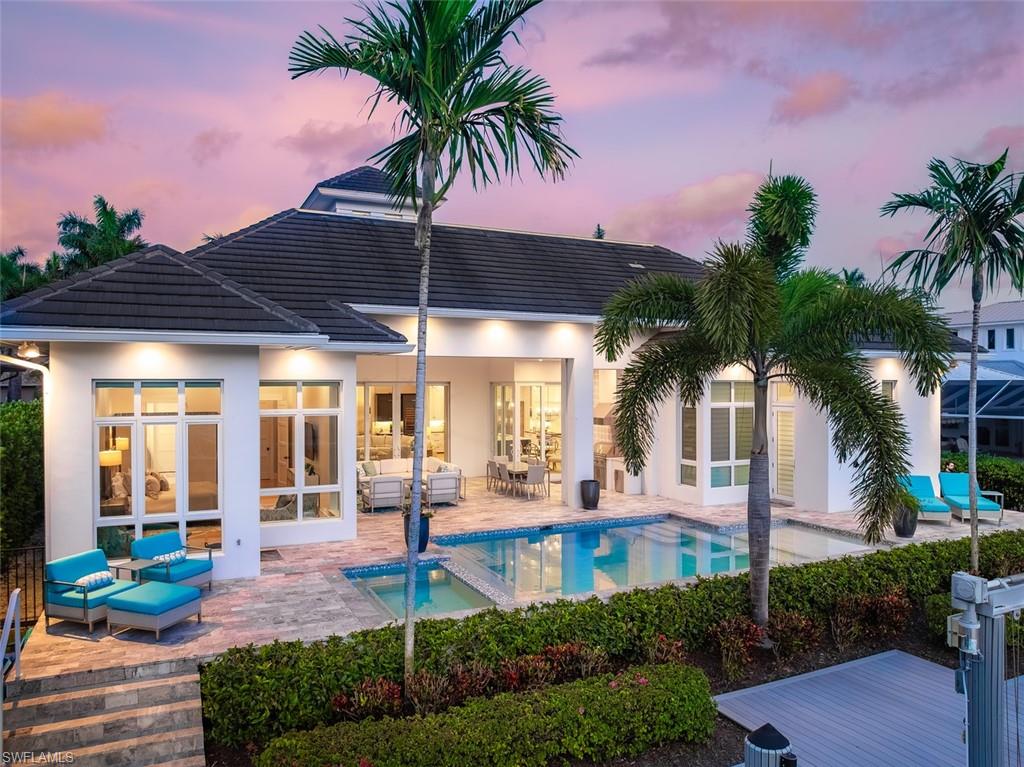 Experience the best of Naples waterfront living in this exceptional custom residence by Greenwald Builders, where superior craftsmanship and thoughtfully curated amenities come together in a timeless coastal-inspired design. Perfectly positioned along a canal in prestigious Royal Harbor, this remarkable single-level home embraces the effortless indoor-outdoor lifestyle Naples is known for. Designed for both relaxed everyday living and sophisticated entertaining, the residence features beautifully appointed indoor spaces that transition seamlessly to expansive outdoor living areas, complete with a sparkling pool and spa, inviting lounge spaces, and the perfect setting for sunset gatherings. With coveted western exposure, evenings are nothing short of spectacular as the sky transforms over the water. For boating enthusiasts, the property offers a direct, no-bridge access to Naples Bay and the Gulf of Mexico—making spontaneous days on the water effortless. Just minutes from downtown Naples, residents enjoy unmatched proximity to the world-class dining, boutique shopping, art galleries, and vibrant charm of Fifth Avenue South and Third Street South, while still enjoying the privacy and tranquility of one of Naples’ most sought-after waterfront neighborhoods. This is coastal luxury living at its finest.