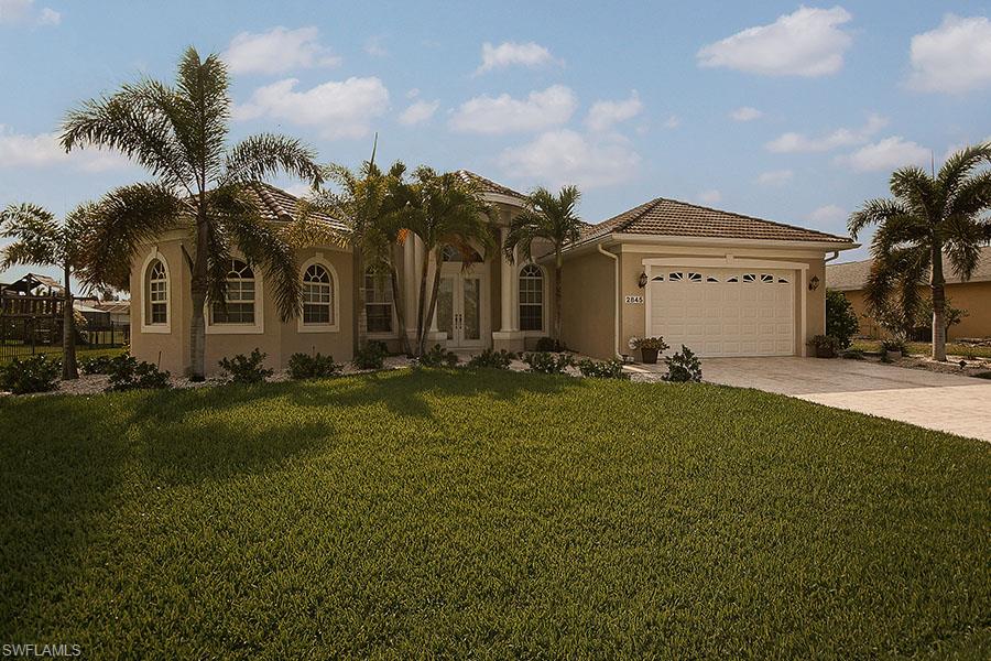 Beautiful DIRECT access waterfront home complete with a 10,000 pound Boat Lift and Captains Walk.  Only minutes to the open water!  The lanai is perfect for entertaining a crowd.  Cook the fresh fish and crabs you freshly caught on your Summer Kitchen!  No walking wet from the pool inside as there is an adorable air-conditioned pool bath!   The lanai is the complete length of the lanai for sunbathing.  Surface of the lanai is made of a material that no matter how hot it is - the surface will not burn your feet!  Enter your new home through the double etched glass doorway (electric storm shutters)into a very nice and open floorplan.  Tastefully decorated throughout (furniture optional).  This is truly what you would expect from a high-caliber home!  Huge master bedroom with a great sitting area overlooking the pool.  California closet in Master bedroom like you won't see in too many homes.  Gorgeous master bath with walk through shower and garden tub.   Seller's will entertain all reasonable offers.