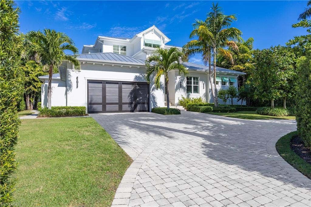 THIS TURNKEY FURNISHED HOME BOAST A .56 ACRE LOT. This Manicured Estate is just minutes via Bicycle to the Moorings Private Beach, the Gulf, and Incredible Sunsets!  If you like elbowroom and privacy you've come to the right place. The large back yard offers plenty of room to have gatherings and other functions.  
Built in 2019, this home was constructed with 25% more structural integrity than required by code, high elevation, impact windows, doors, 40-year metal roof, and much more. The Circular Driveway allows for safe access onto quiet and prestigious Spring Line Drive.  This Grand Entryway with Double Doors leads you into this fabulous home.  The Large Open Floor Plan allows for a nice flow between the Kitchen, Dining and Living Rooms.  
The Kitchen Officers Beautiful White Cabinets, Quartz Counters, Stainless Steel Appliances, and a Large Island. The large Walkin Pantry is a nice addition. 
The Living Room has a Tongue and Grove Ceiling, Wood Plank Tile Floors and a Terrific View of the Amazing Pool and Back yard. The Sliding Glass Doors can be opened, the Lanai Screen Panels can be lowered with a push of the button, and the Tall Front Doors have a retractable screen which allows for amazing cross breezes.
Also located on the First Floor, is a Separate Family Room.  This room has a lot of versatility and could also be used as an executive home office, a library, or a movie room.   
The First Floor Master Bedroom has a wonderful view of the pool area and large lush, landscaped back yard.  The stunning Master Bathroom offers a walk-in shower with dual heads and entrances on each end.  There are his and her vanities with each providing plenty of counter space.
There are two Half Baths located on the First Floor as well as a Large Laundry Room.

The two Guest Suites are located on the private Second Floor and have their own Full Bathrooms with walk-in showers.  Both Suites offer stunning views of the backyard. The Second Floor offers a Quiet Living Area for family or guests along with a big screen tv, sofa, refrigerator, and a counter to place refreshments.
The Lanai area offers a Tongue and Grove Wood Ceiling, Electric Storm Shutters and Screens, and nice furnishings.  The Pool Deck is approximately 1750 square feet which includes beautiful decking and a 16X30 Pool.  This area is surrounded by lush landscaping to include but not limited to a beautiful lawn, different types of plantings along with tall hedges which offer tremendous privacy for not only the pool area but the entire property.