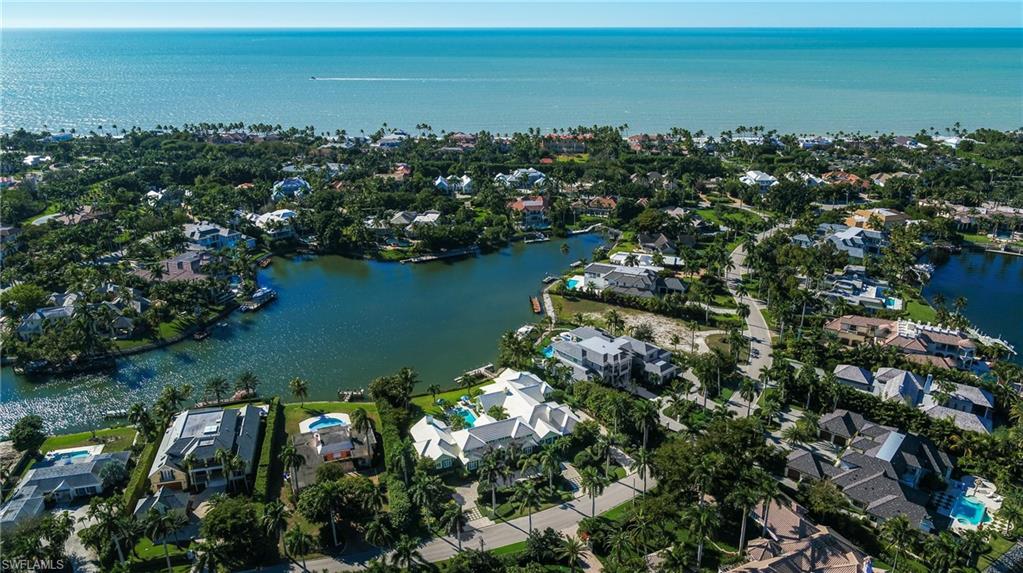 Once-in-a-generation opportunity to own the rarest of rare lot-and-2/3 estate home with 150 feet of southwest exposure navigable waterfront over Old Harbour Cove in Port Royal. Elegance and proportion define this classic six bedroom home with Kennedy-esque lawn just steps to the exclusive Port Royal Club on the Gulf of Mexico. From the minute you walk into this utterly charming home, you'll be delighted by its light, architecturally classic spaces and timeless selections. Six bedroom suites and several living areas are spread out in the 6,780 s.f. home, with an additional 4,000 s.f. of space under roof. A perfect scale home in a supremely serene setting with wide bay views set squarely in the heart of arguably the most elegant street in Port Royal. Immediate Port Royal Club membership opportunity.