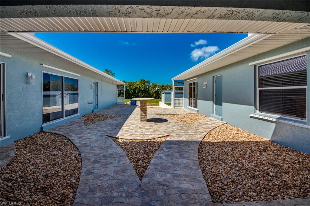 HUGE PRICE DROP!!!  RARE Pineland home on almost TWO acres!  This courtyard style home is all you need to enjoy a peaceful, Island life.  Plenty of room to store your toys or add a pool.  The main house features two living spaces along with 3 bedrooms, 2 full bathrooms, along with a half bath for guests.  The master bedroom and bathroom have been updated and have 2 large walk-in closets.  You will love spending time in the courtyard, that open to the Florida sun.  The guest house is overlooking the courtyard and has a bedroom, full bathroom & living space as well.  A few upgrades to mention- new a/c, exterior paint, gutters, roof, fence and whole home security system (cameras included!).  This property remained high and dry from Hurricane Ian!  Just minutes from the historical Tarpon Lodge, multiple boat ramps, Calusa Nature Trail & Bokeelia Post office.  Pine Island living offers some of the best shallow-water fishing in the world!