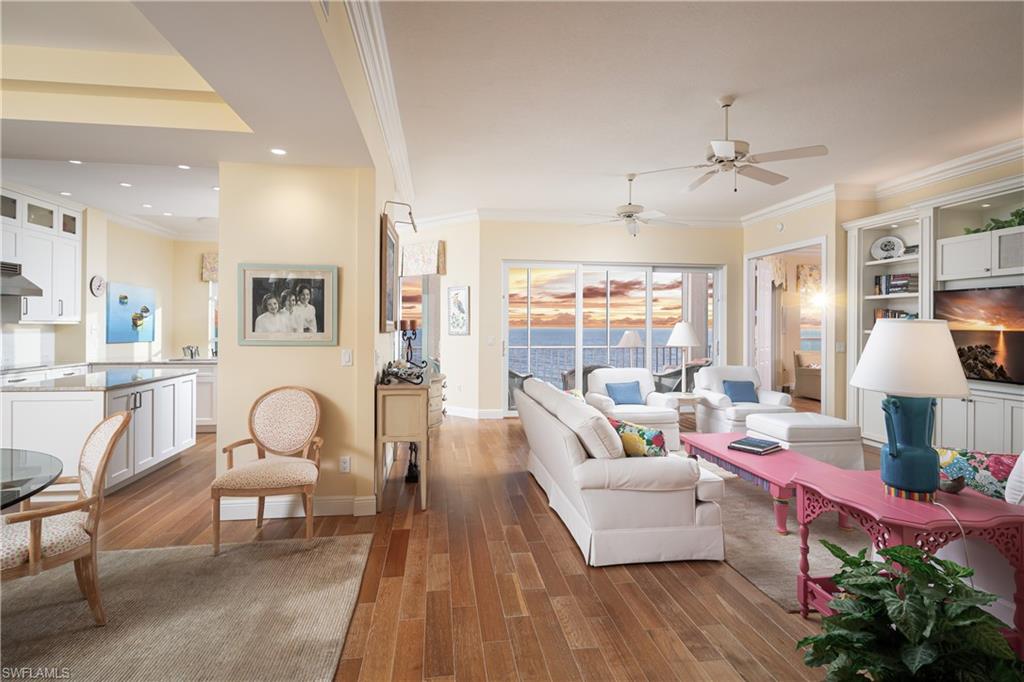 THE FIRST DIRECT BEACHFRONT D-UNIT PENTHOUSE OFFERED IN BAREFOOT BEACH IN 5 YEARS! This beautifully renovated unit offers one of the 2 largest floor plan types in the Barefoot condos! Indulge in sweeping, panoramic views of the Gulf and breathtaking sunsets. This coastal delight features an open floor plan spanning 2,266 sq ft under air, with 3 spacious bedrooms, 3 bathrooms, wood flooring, & extra-high ceilings exclusive to penthouses. Equipped with full storm protection, this unit boasts hurricane impact windows and sliders, electric hurricane shutters, and a newly installed roof on the building. Relax and unwind on your screened-in lanai, where you’ll enjoy views of boaters cruising by, along with occasional sightings of dolphins and manatees in the distance. The spacious chef’s kitchen includes beautiful quartz countertops, crisp white cabinetry, & high-end stainless-steel appliances. Adjacent to the kitchen, you’ll find a formal dining area with custom built-ins and a wine fridge, ideal for entertaining guests. The well-designed split floor plan ensures privacy and comfort, with two guest bedrooms located at the front of the unit, while the serene primary suite is positioned on the waterfront side offering a peaceful retreat with breathtaking Gulf views and private lanai access. The suite also features an expansive walk-in closet and a spa-like bath with dual vanities, a soaking tub, and a frameless glass shower. The Club at Barefoot Beach includes fine & casual dining, private pool, tennis courts, beachside food & beverage service, planned social activities & more (WITH A MEMBERSHIP). Nearby to the NEW CLUBHOUSE with state-of-the-art fitness center & resort-style pool. Enjoy 3 miles of Gulf-frontage, 2 beachside pools/spas, fitness center, 24-hour manned/gated entry & on-site mgmt. Located minutes to Mercato, Waterside & easy access to RSW Airport.
