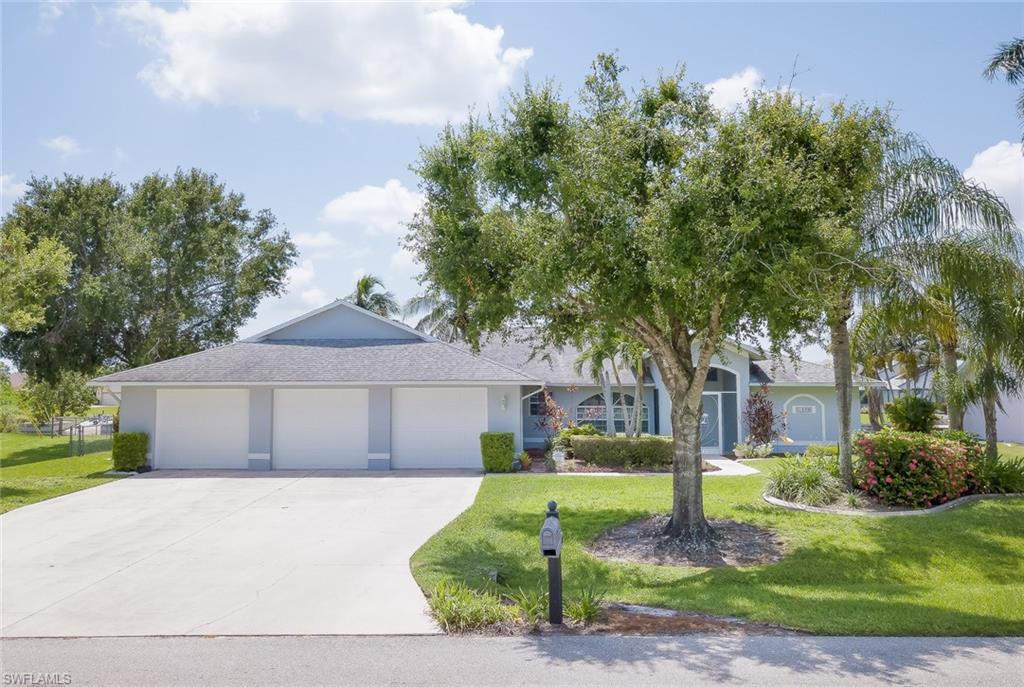 ASSESSMENTS PAID!! This IMMACULATE four-bedroom pool home on a triple lot, with a fenced yard, located on a freshwater canal with a view of Shamrock Lake creates the perfect atmosphere for living or relaxing. With over 2300 square feet, this home offers a formal living and dining room, large kitchen, breakfast nook, family room, 3 guest bedrooms and a master bedroom with an attached office / hobby room.  With 3 sets of sliders that lead to the lanai with screen panels that enclose the outdoor-eating area and provide safety fencing to the pool. Enjoy evenings in your heated pool, watching the sunset over Shamrock Lake.  Lots of custom features: built-in laundry sink and cabinets, air-conditioned attic space, 3-car garage, mature landscaping, updated master bathroom with raised dual sinks, exterior freshly painted, NEW 2017 AC and many more!  Schedule to see your new home today.  Great for a seasonal rental, family home or winter getaway!