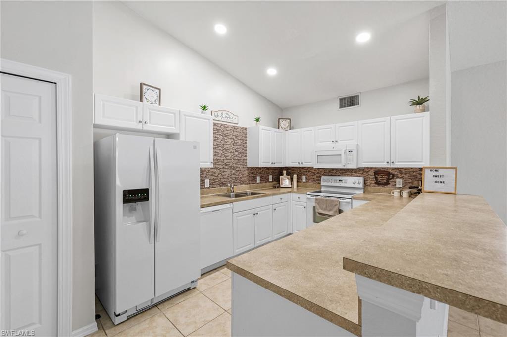 Looking for a cute condo? Well here it is!This 2nd floor gem offers a spacious and inviting open floor plan, featuring 2 bedrooms and 2 bathrooms for your comfort and convenience. As you step inside, you'll immediately notice the airy, open feel of the living space. This condo boasts a modern touch with no carpets, a generous kitchen featuring crisp white cabinets, stylish backsplash, and white appliances. The large bedrooms provide ample room for relaxation and privacy. Step out onto the wide lanai, where you can savor your morning coffee while overlooking the beautifully landscaped area. The stackable washer and dryer add to the convenience of everyday living. Pool and spa just steps away! Investors, take note – this condo also offers great potential rental income, making it a savvy investment opportunity. Don't miss your chance to be a part of this charming Key West-style community consisting of just 56 units. Indulge in culinary delights at nearby restaurants, easy access medical care at nearby hospitals/urgent care, cool off at the waterpark, or shop 'til you drop with plenty of shopping options. Your perfect Florida lifestyle awaits!