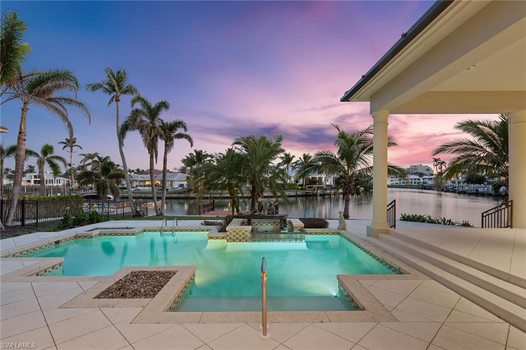 Your perfect waterfront property awaits with panoramic south-facing bay views and an astounding 265 feet of water frontage! Situated on .51 acres, this one-of-a-kind property can accommodate an expansive coastal retreat that will capture its incredible wraparound bay views. Build an approximate 6,700-square-foot two-story dream home on the site or choose to remaster the current home's 5,100 sq. ft. of living space. This property is perfectly situated just steps from the private Moorings beach access and down the street from the upcoming Four Seasons resort and renowned 5th Avenue. With its incredible size, view, and location, the opportunities are endless!