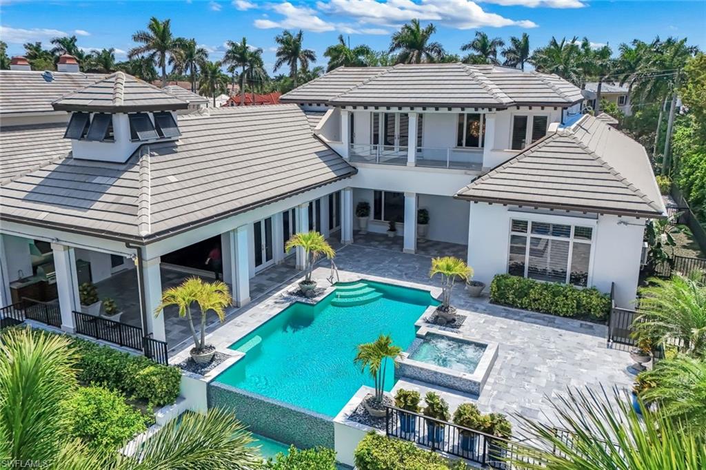 One or more photo(s) has been virtually staged, AI generated or rendered.  One of the best-valued waterfront opportunities in Port Royal, priced below appraised value, 605 Galleon Drive combines an exceptional location on the coveted Jamaica Channel, deep-water boating, and immediate eligibility for Port Royal Club membership—making it a compelling offering in today’s market.
Ideally positioned near the entrance of Port Royal, the home offers quick and convenient access in and out of the community, while being just moments to the private Port Royal Beach Club. Immediate membership eligibility is a significant advantage, allowing a new owner to enjoy one of Naples’ most exclusive beachfront clubs without delay.
Set along the wide Jamaica Channel—one of Port Royal’s most desirable waterways—this property delivers expansive water views and an extremely short idle to Naples Bay, providing fast, direct Gulf access. The dock accommodates up to a 60-70 foot vessel, and the dock area has been dredged to approximately 7 feet, a rare and highly valuable feature that enhances usability for larger boats.
Built by BCB in 2011, the residence showcases quality construction and timeless design. From the moment you enter, the attention to detail is evident. A striking living room with a see-through fireplace flows seamlessly into the dining and great room, creating an ideal layout for both everyday living and entertaining.
The light-filled kitchen is both functional and inviting, featuring a large walk-in pantry, a gas cooktop, and an open concept that allows for effortless hosting. The primary suite is spacious and private, complete with dual designer closets and a well-appointed bath.
Upstairs, three generously sized en-suite bedrooms provide comfort and privacy for guests, complemented by an additional laundry room and a versatile loft perfect as a media room or relaxed lounge.
Outdoor living is designed to capture the Naples waterfront lifestyle, featuring a screened-in lanai with motorized screens, a summer kitchen, and a pool bath—allowing you to effortlessly transition between open-air and protected comfort. The pool and spa overlook the wide Jamaica Channel, offering a serene setting to relax or entertain while watching boats pass by. The property is fully fenced and includes a dedicated dog run, providing both privacy and convenience.
Constructed with durability and peace of mind in mind, the home features impact glass throughout, complemented by additional hurricane shutters that provide enhanced protection for the covered outdoor living areas.
For buyers seeking a premier boating location, beach club eligibility, and strong overall value in Port Royal, this property stands out as a rare opportunity.