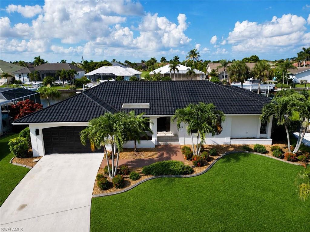 Welcome home to million-dollar views and the best of waterfront living!  This FULLY RENOVATED beauty delivers a rare blend of modern design, comfort, and a true Florida Lifestyle. Thoughtfully redesigned for effortless single-level living and accessibility, the home features a bright open-concept floor plan tailored for both everyday comfort and entertaining.  With seamless indoor-outdoor flow that creates an inviting atmosphere and connects expansive living spaces to outdoor entertaining areas. No detail was overlooked in the extensive top-to-bottom renovation, including beautifully REMODLED BATHROOMS, upgraded countertops, NEW FLOORING throughout, fresh interior and exterior paint, enhanced lighting, an epoxy-coated garage floor, and a FULLY RENOVATED KITCHEN with new appliances and quartz  countertops. The outdoor living space has been significantly enhanced with new screens, professionally sealed back patio and a convenient pool-access bathroom. There is a custom outdoor bar area along with a fully operational 10,000 lb. boat lift that provides direct water access and elevates the true waterfront lifestyle. Additional improvements include added attic insulation for energy efficiency, a recently serviced irrigation system, and a professionally reviewed electrical system for code compliance and peace of mind.  Modern spot-resistant shower glass coatings add a practical touch of low-maintenance luxury.  Prime location conveniently located near top-rated golf courses, dining, and amenities.  A true rare opportunity that offers the perfect balance of privacy and luxury in one of the most desirable communities in all of Punta Gorda!  NEVER FLOODED.  Come discover the best of the best of waterfront lifestyle, where quality renovations meet exceptional location.  Easy to show and easy to close.  Call today!