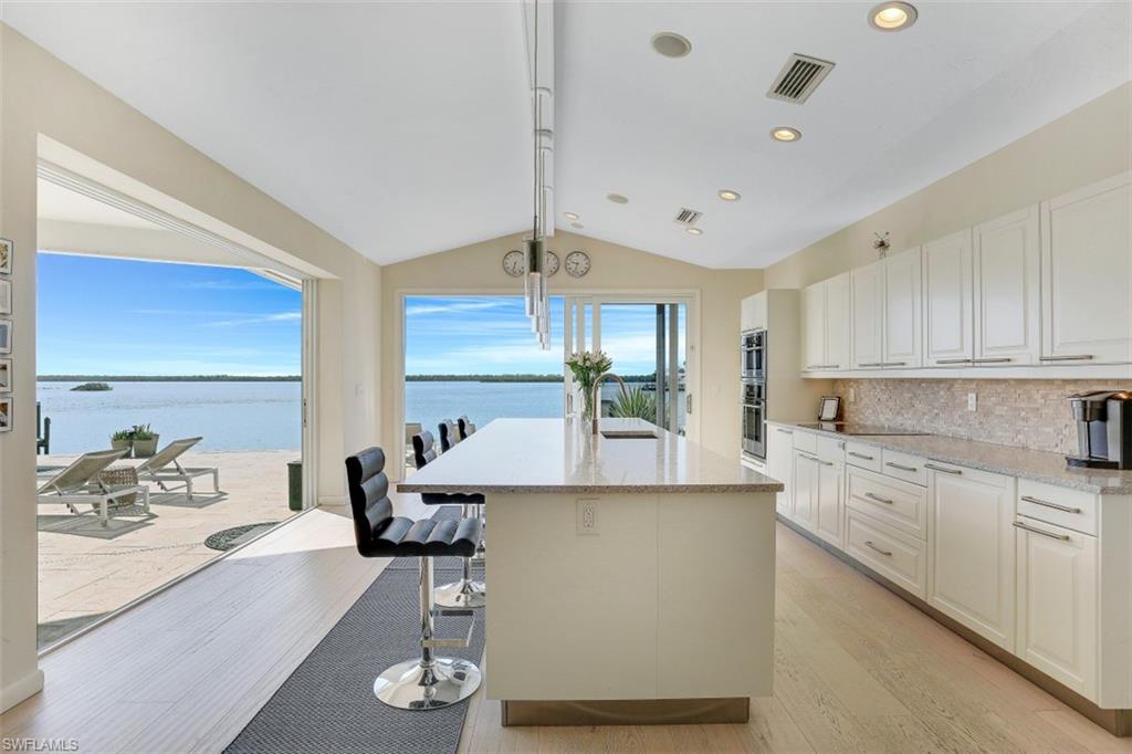 SW exposure with UNSURPASSED VIEWS OF CAXAMBAS PASS, sunsets and the mangroves of the 10,000 Islands chain. A long 343 ft deep leg, 229 ft deep leg and 130 ft on the water. One of the perimeter sites found in the estates section of Marco Island. Located next to homes that sold for over $8 million. Totally renovated in 2016.. new floors, new bathrooms, new kitchen- all done with an open feeling throughout. The home site is .86 acres which is large enough space to build your mansion and still have space for your privacy. Plenty of boat traffic to watch with over 3,500 ft of water views (almost 1 1/2 miles) to the next island. A contemporary flair through out the entire renovation with very clean lines. Large great room is a spacious 27X21 ft area. Be MESMERIZED by the views! Brand new (2020) seawall and dock! The views from this home are absolutely outstanding! Breathtaking, jaw dropping SW exposure. HUGE views! There are plans drawn to move the garage to the south side, expand the bedrooms into the current garage and make the back room a glassed in view room if interested. Someone could build a mansion with .86 acres!