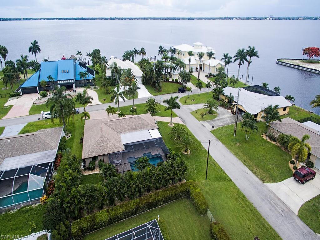 H.12123 - Unbelievable value for this upgraded home in the very sought after neighborhood of Palaco Grande. You will not find another one that compares at this price.  New Pool, Roof, Impact Windows, and Doors in 2015.  Oversized corner lot with pristine landscaping and amazing river views.  Extra large semi circle clay paver driveway allows several cars for entertaining company.