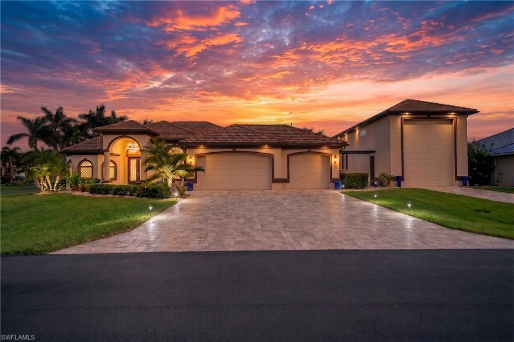 Walking distance to Cape Harbour! RV garage with Car Lift. Detached Guest House. Stunning custom residence; this extraordinary property delivers 2,900 square feet of updated living space across a 4-bedroom plus office/den, 4 bathroom floor plan on an oversized .37-acre corner lot. Walk or ride your golf cart to Cape Harbour Marina in minutes and come home to a level of privacy, space, and lifestyle that this neighborhood delivers like no other! Soaring vaulted and coffered ceilings. Wood tile plank flooring anchors the main living areas, with a dramatic feature wall, electric fireplace, and built-in bookshelf accent nooks in the living room. The chef's kitchen delivers exotic granite countertops, classic white cabinetry, an espresso island, gas range, wall oven, and a newer appliance package all open to the great room. The primary suite overlooks the pool through French doors, with a spa bath featuring dual vanities, a walk-through shower with 7-plus heads and body jets, Premium whole-house water filtration system, and custom closet systems. Updated guest baths, a front office with tall ceilings, and a brand-new laundry room with stacked LG washer and dryer, sink, cabinetry, and backsplash complete the interior. Outside, the 1,159-square-foot screened pool enclosure features a just resurfaced custom pool with a wrap-around sitting ledge, oversized integrated hot tub with spillover, and heated. Stunning pecky cypress lanai ceilings, outdoor kitchen with built-in grill & bar seating, and ample space for dining, sunbathing, and entertaining. Motorized storm shutters hidden in the soffits protect every opening at the touch of a button. A whole-home propane generator. The garages alone set this property apart. The attached 3-car garage features a mini-split AC system with one bay currently configured as a home gym. The detached RV garage is the crown jewel a massive high-clearance garage with epoxy floors, transom windows, a motorized loft hoist, a foldable ladder, and a car lift system. Together, nearly 1,500 square feet of premium covered space purpose-built for RV motor coaches, boat storage, car collections, motorcycles, and more. This is the setup serious collectors spend years trying to find. 1-bed, 1-bath guest apartment sits privately on the rear of the RV garage. Flat tile roof, paver driveway, lush corner lot landscaping, city water & sewer. The property sits on a private, one-way-in street with 6.36-acre Camelot Park across recently renovated in 2026 w/ PICKLEBALL, tennis, and walking paths. Cape Harbour delivers the crown jewel of SW Florida waterfront living waterfront dining at Rumrunners and Fathoms, the iconic Lighthouse Bar with live music, the Cape Harbour Oyster Bar, The French Press, Dockside Juicery, a 76-slip full-service marina, Freedom Boat Club, fishing charters, sunset cruises, weekly Farmers Markets, the Cape Harbour Boat Show, Brews Blues and BBQ Festival, and events.
