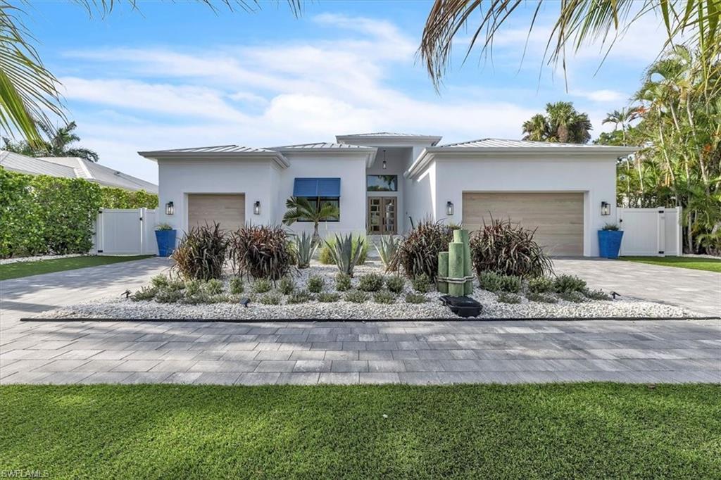 Welcome to the beach HAVEN…This coastal modern home sits elevated plus in an X-FLOOD ZONE only 1.2 miles from the BEACH!!! Beautifully appointed, this 2023 custom built home offers GAS, standing seam METAL ROOF, IMPACT windows & doors & is just shy of 3000 ft.² Consisting of 3 BEDROOMS, DEN/OFFICE w/ built-ins, 3 full BATHROOMS, 3 CAR GARAGE w/ side mount openers room for car lifts. It offers an open floor plan w/ ceiling heights up to 15’, walk-in custom closets in EVERY bedroom, a HUGE oversized island that seats 8 + storage, 48” Monogram double ovens w/ griddle, 42” Monogram refrigerator, pot filler, jetted tub, bidet & MORE! This house is GREAT for entertaining w/ a CIRCULAR DRIVEWAY, built-in OUTDOOR KITCHEN w/ bar, LARGE covered lanai w/ GAS FIREPLACE, saltwater lap POOL & SPA. It greats better…save $$$ on landscaping w/ this homes maintenance-free grounds of NO GRASS & NO MULCH…just beautiful artificial turf & white shells EVERYWHERE! The beach HAVEN home has so much to offer + an AMAZING LOCATION downtown surrounded by GREAT restaurants, shops & parks…Book Your Showing Today!