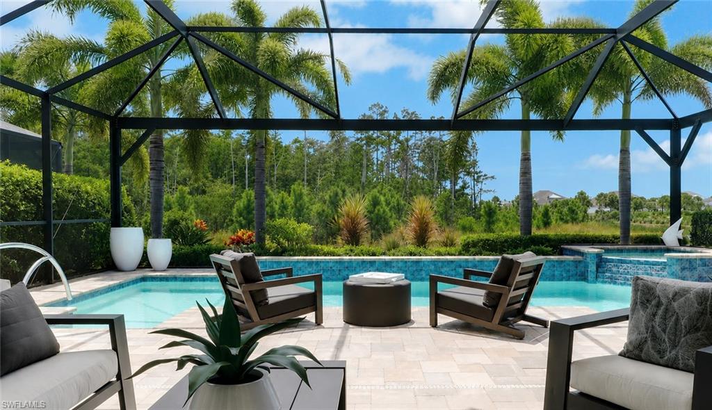 Welcome to your dream oasis in sunny Naples, Florida.  This stunning contemporary Gardenia model pool home perfectly positioned on one of the most desirable lots in The Isles of Collier Preserve, offering an unparalleled blend of modern luxury and serene natural beauty.  With breathtaking preserve views to the rear and expansive water views to the South, this residence provides a truly private and tranquil setting. Featuring 2-bedrooms plus a spacious den (optional 3rd bedroom) the home is filled with custom upgrades, designer touches, and a versatile open-concept layout perfect for both entertaining and everyday living. As you step inside, you'll be greeted by an atmosphere of elegance and comfort, highlighted by new light fixtures, ceiling fans, plantation shutters, custom wallpaper, tray ceilings and crown molding throughout. The spacious great room flows effortlessly into the dining, and gourmet kitchen areas, where a custom-built Dimplex fireplace TV feature wall enhances adds a sophisticated touch.  Sliding glass doors flood the interior with natural light and offer picturesque views of the surrounding landscape. The kitchen is a chef's dream, featuring stainless-steel appliances, 2 built in ovens, wine fridge, waterfall quartz countertops, solid quartz backsplash with ample cabinet space & coffee bar. Whether cooking a quiet meal or hosting a dinner party, this kitchen is sure to impress. The luxurious primary suite provides a peaceful retreat, complete with an en-suite bathroom and his and hers walk-in closets. Wake up to serene preserve and lake each morning and unwind in the evenings with a glass of wine on your own private lanai. Step outside to your own personal paradise, where a screened-in lanai with built in outdoor kitchen sets the stage for al fresco dining. The sparkling pool with waterfall hot tub is the perfect spot to cool off on warm afternoons or relax under the stars in the evenings. With its prime location in Naples next to the the US Open Pickleball Center and just minutes from Naples Iconic 5th and 3rd avenues, you'll enjoy easy access to world-class shopping, dining, entertainment options, as well as Naples pristine sugary sand beaches and championship golf courses. The Isles of Collier amenities include a grand clubhouse, state of the art fitness center, resort style walk-in pool, lap pool, spa, saunas, tennis, 12 pickle-ball courts, boccie, hiking, biking, kayak launch, dog parks and boat tours on the Cypress Waterway. With a full social calendar of lifestyle events, parties, and gatherings, there's never a dull moment at The Isles of Collier Preserve.  Onsite, the Overlook Bar & Grill offers lunch, dinner, and evening entertainment without leaving the community. Don't miss your chance to own this exceptional property – schedule your private showing today!