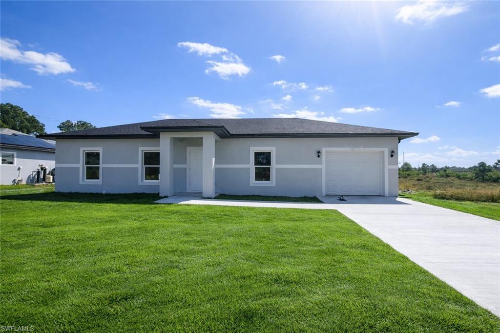 Introducing our NEW CONSTRUCTION - a modern 3 Bed / 2 Bath Home in the heart of Lehigh Acres, FL. This stunning home boasts a sleek design with beautiful tile flooring throughout and an abundance of natural lighting. The kitchen is a chef's dream, complete with granite counters, wood shaker cabinets, and a full suite of stainless steel appliances. The primary bedroom is a true retreat, featuring an en-suite bathroom for added convenience. Two additional spacious bedrooms and a guest bathroom with a tiled shower/tub combo provide ample space for everyone. The home also includes a one-car garage and a washer and dryer hook-up. The exterior is just as impressive with storm protection-impact windows and a covered rear lanai, perfect for enjoying the Florida weather. This brand-new construction is conveniently located close to all amenities in Lehigh Acres. Photos may be of a model and not of actual property - for marketing purposes only