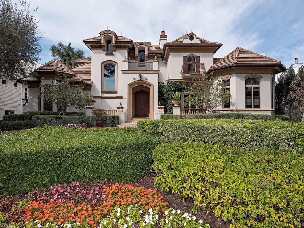 H.13416 - Wonderful & well-built in 2007! Open & bright, loaded w/upgrades! Absolutely ideal location in the heart of Olde Naples just 5 doors to the beach, 3 blocks to 5th Ave & 3rd St for the best shopping & dining! Luxurious ground floor master suite has a sitting area, two walk-in closets, separate vanities, soaking tub, king-sized shower! Also, there's a ground floor guest suite plus an elevator to 3 more spacious guest suites upstairs enjoy access to a covered balcony for glorious sunsets. Impeccably maintained, tasteful, casually elegant 5849 sq ft LA home w/5 BR+ Den, 4 full+ 2 half BA. Alley access to rear entry 3+ car garage Coffered volume and cathedral ceilings, granite, marble and onyx countertops, fireplaces, split bedrooms for privacy, chef’s kitchen, large impact picture windows with tropical landscape views, plantation shutters on most windows. Manicured grounds, brick paved circular drive. Open floor plan offers multiple areas for entertaining.  Tropical lagoon pool and spa beckon guests outdoors to enjoy the patio and summer kitchen amidst the lush environs.