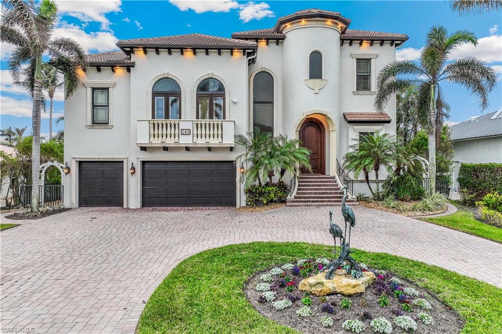 WOW, another price reduction- an incredible value you don't want to miss. This exceptional, high-quality home offers DIRECT GULF ACCESS and is just a short stroll from the BEACH. Included in the price is an impressive 30-FOOT BOAT and two JET SKIS, making this a dream opportunity for boating and sun enthusiasts. The property features a spacious dock, a powerful 28,000-lb boat lift, a secondary lift for a jet ski, a seawall, and a durable fiberglass deck board. This Southern-exposure residence has been meticulously designed with every detail in mind. Step through the stunning 10-foot arched mahogany front door and into a spacious, welcoming interior with an open floor plan ideal for both relaxing and entertaining. This quality, custom-designed home is being sold furnished with elegant pieces throughout. Showcasing exceptional craftsmanship and attention to detail, the residence offers 4 spacious bedrooms, a den with custom-built-in shelving ideal for a home office, and 4.5 bathrooms. The light-filled living and dining areas flow seamlessly into a welcoming family room, perfect for entertaining or relaxing. The formal dining and living areas are combined, featuring a fireplace with a wall of French doors leading to an outdoor covered terrace overlooking a wide canal. Notable features include extensive crown molding, high ceilings, hidden A/C vents, impact windows and doors, plantation shutters, and an elevator that provides access to all three levels. Energy efficiency meets modern living with 27 solar panels, Tesla power banks, spray foam attic insulation, and a 3-car garage. A specious family room offers large picture windows, a volume ceiling with wood beams, and is adjacent to a large kitchen. The gourmet kitchen is a chef's dream come true. It is equipped with a six-burner gas cooktop, warming drawer, Sub-Zero refrigerator, wine cooler, stainless steel appliances, a walk-in pantry, breakfast bar, and stunning granite countertops. The primary suite is a true retreat, accessed through double doors and offering a private seating area, two spacious walk-in California closets, and a private balcony for quiet moments outdoors. The luxurious en-suite bathroom features dual vanities, a Jacuzzi tub, a bidet, and a separate large walk-in shower. Each guest bedroom includes its private bathroom, with one bedroom conveniently located on the first floor, perfect for hosting guests. The outdoor space is just as impressive as the interior, featuring a spacious lanai, a fully equipped outdoor grill, ample lounging areas both covered and open, and a heated pool and spa to create a favorable entertaining space for family and friends or enjoying peaceful, private evenings. Conveniently located close to Marcatto Shopping Center, Whole Foods Market, Restaurants, Golfing, Boating, and many other attractions. This is more than a home-it's a lifestyle! Unbeatable Conners/Vanderbilt Beach Location!