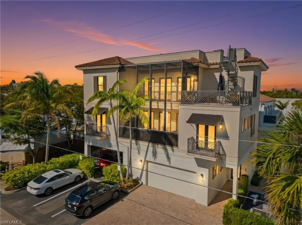 This elegant and expansive detached villa offers a rare lifestyle opportunity in the heart of Naples, just steps from the shops and restaurants of Third Street South. Built by Hemmer Construction, the residence features 3 bedrooms, 3 full baths, and two gas fireplaces.

The open-plan living area is ideal for entertaining, with French doors opening to a spacious lanai. The gourmet kitchen is equipped with gas cooking, Sub-Zero and Miele appliances, and high-end finishes throughout. Flooring includes a mix of tile, hardwood, and carpet, complemented by impact-resistant doors and windows.

The private primary suite occupies the third level and includes a spa-like bath with walk-in rain shower, soaking tub, Caesarstone vanity tops, and a generous walk-in closet. Juliet balconies enhance both the guest suite and main living areas, while the primary bedroom offers access to a lanai and an upper rooftop deck via a spiral staircase.

Additional features include an elevator, front-door camera security system with alarm, and a private 3-car air-conditioned garage currently configured as a 2-car space with storage, pre-wired for a vehicle lift. Excellent rental potential.