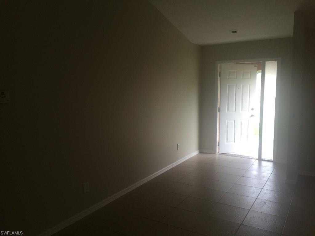 Nice great room floor plan with 3 bedrooms and two bathrooms.  New  paint and carpet.  Owner just put on a new roof.   House has an under truss lanai that is unscreened.  Open kitchen with dining area.  Great room, kitchen and Dining is tile.    Fenced yard.  Home needs some TLC.  This is an area of utilities expansion.  Buyer to assume all current and future assessments, capital expansion / impact fees.