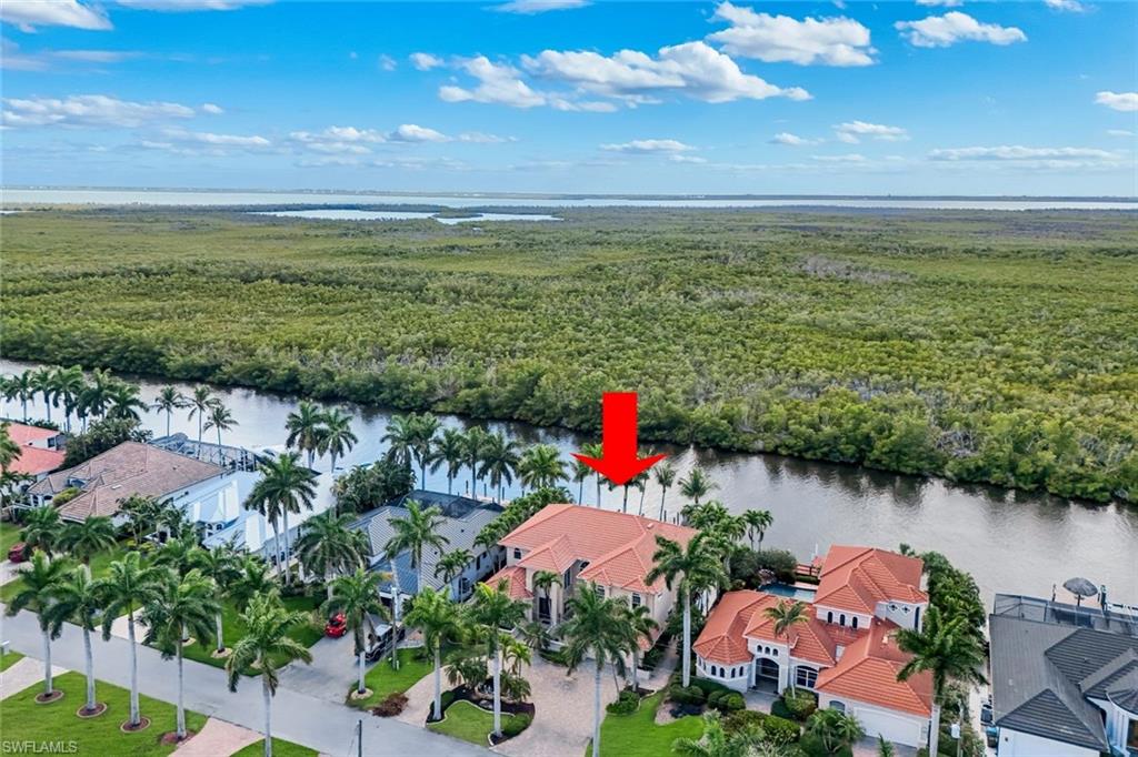 Positioned on a quiet cul-de-sac in the prestigious Peninsula Pointe neighborhood near Cape Harbor, this extraordinary waterfront estate sits directly on the wide SPREADER CANAL — one of Southwest Cape Coral’s most coveted deep-water addresses, offering true DIRECT GULF ACCESS for vessels of all sizes.
With 80 feet of prime water frontage, a 10,000 lb. BOAT LIFT deep-water mooring for larger vessels, and a kayak launch, this property is a boater’s dream from day one.
Every evening, watch the sun sink behind the protected mangrove preserve directly across the canal — private, unobstructed, and unforgettable. Dolphins and manatees are daily visitors. This is not a lifestyle you can manufacture — it’s one you have to find.
The Home — 3,744 Sq Ft of Coastal Luxury
This custom two-story concrete block residence (solid construction on both levels) delivers 4 bedrooms, 4 full baths, and sweeping water views from virtually every room. At 3,744 sq ft, there’s room for everyone — and then some.
• Soaring ceilings and open-concept living with pocketing sliders that open to the water
• Florida coral stone tile floors
* Indoor Sauna
• Chef’s kitchen — SubZero refrigeration, Viking gas cooktop, double Miele ovens, granite counters and custom cabinetry
• Main-level bonus room with full bath — ideal as a 4th bedroom, office, or private guest suite
• Upper-level master suite with sweeping canal views, exercise room, and dry sauna
• Two additional guest bedrooms, each with private full bath
Resort-Style Outdoor Living
The 15’ x 41’ pebble-finish pool with rock waterfalls, heated spa, and expansive stone deck. Lush tropical landscaping with professional uplighting, electric hurricane shutters, and a circular paver driveway with fountain sculpture complete the picture.
Income-Producing. Multi-Generational. Move-In Ready.
With a proven vacation rental track record, this property performs as well as it lives. Whether you’re envisioning a multi-generational retreat where families can enjoy plenty of space comfortably, a high-income short-term rental investment, or your own piece of Southwest Florida paradise — this home delivers on all counts.
Offered fully turnkey. Bring your boat, your family, and your sunset glass.
